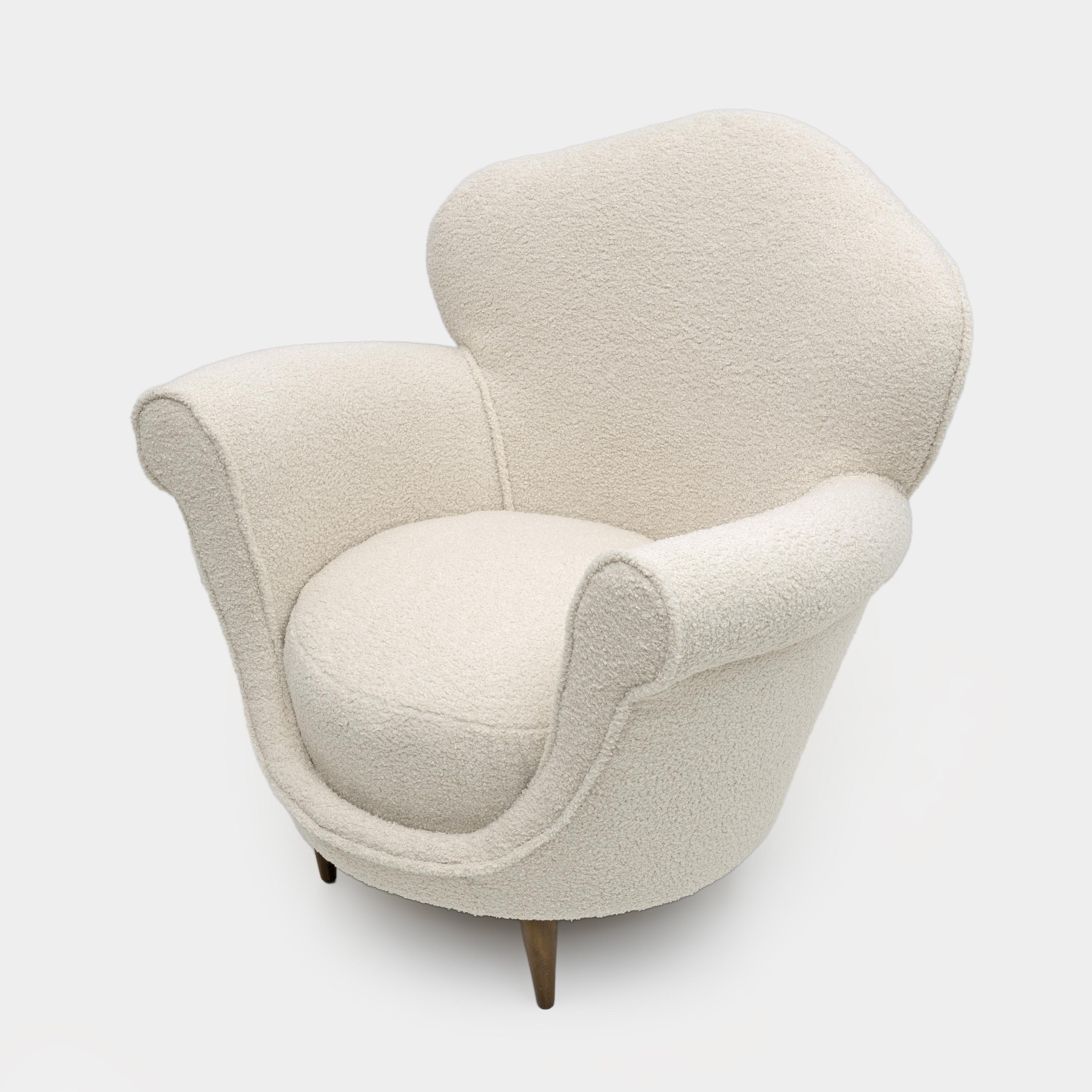 Armchair with curved backrest and rounded shape, Italian design from the 50s. The armchair has been completely renovated in our laboratories, with new padding and springs for maximum comfort. It has been covered in Bouclè fabric. Ready to furnish