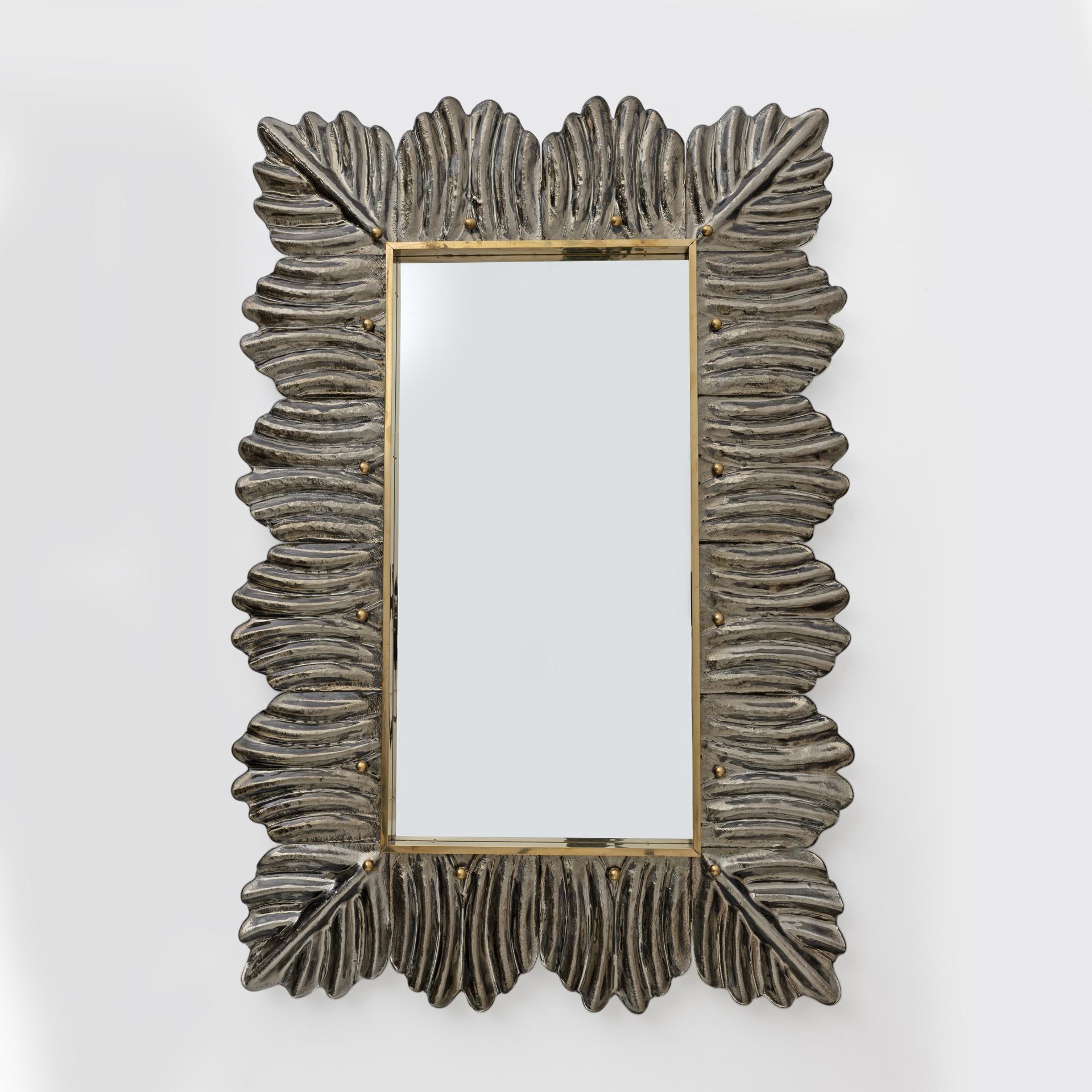 Wall mirror in bronze-coloured Murano artistic glass. With a beautiful shape and excellent dimensions, the wall mirror is a real design object. The structure of the wall mirror is made of wood, where the Murano glass is housed. The mirror frame is