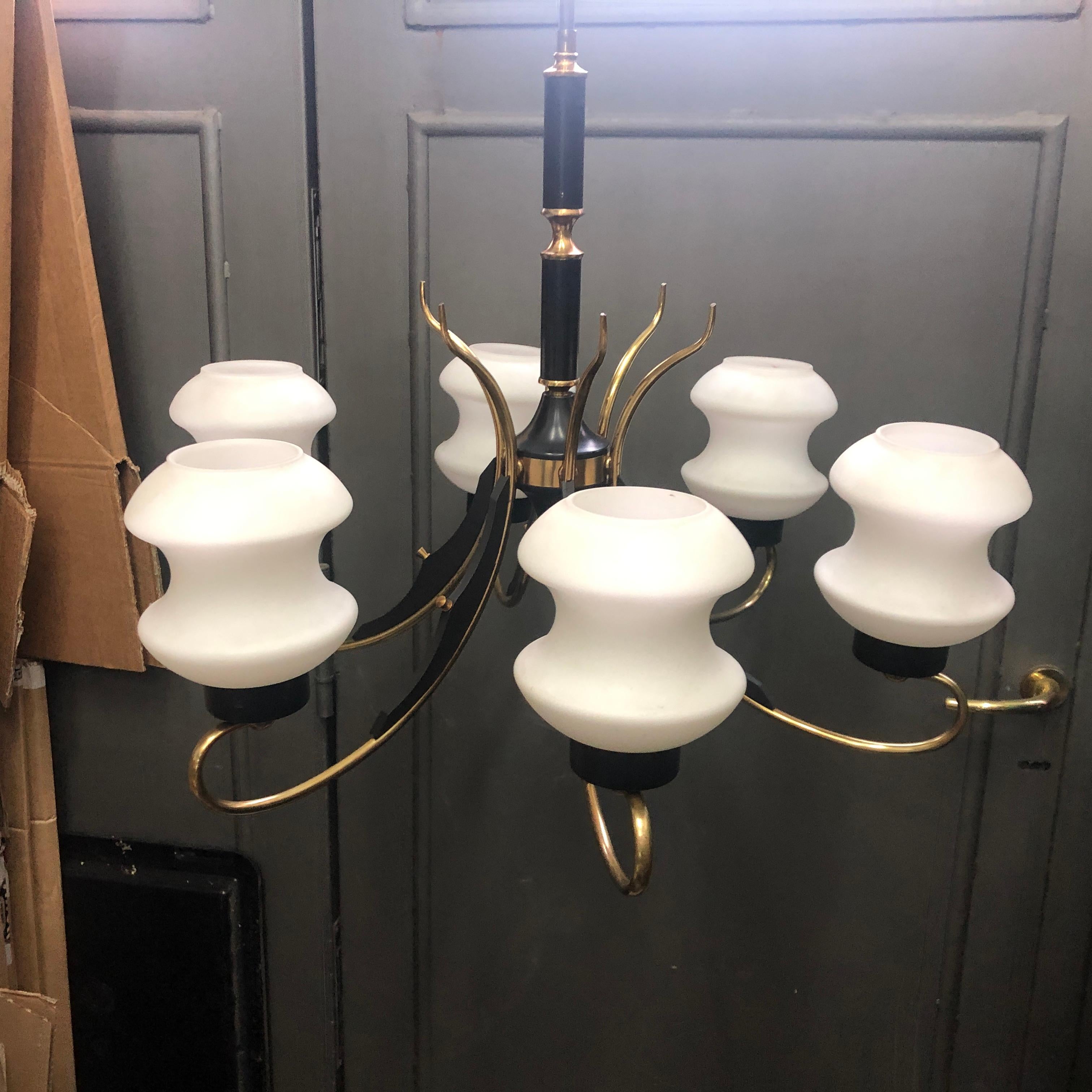 A Mid-Century Modern chandelier in the style of Stilnovo, six lights, in perfect working order. It works with both 110 and 220 Volt and needs regular e14 bulbs. Opaline white glass diffusers are in perfect conditions, ebonized wood and brass parts