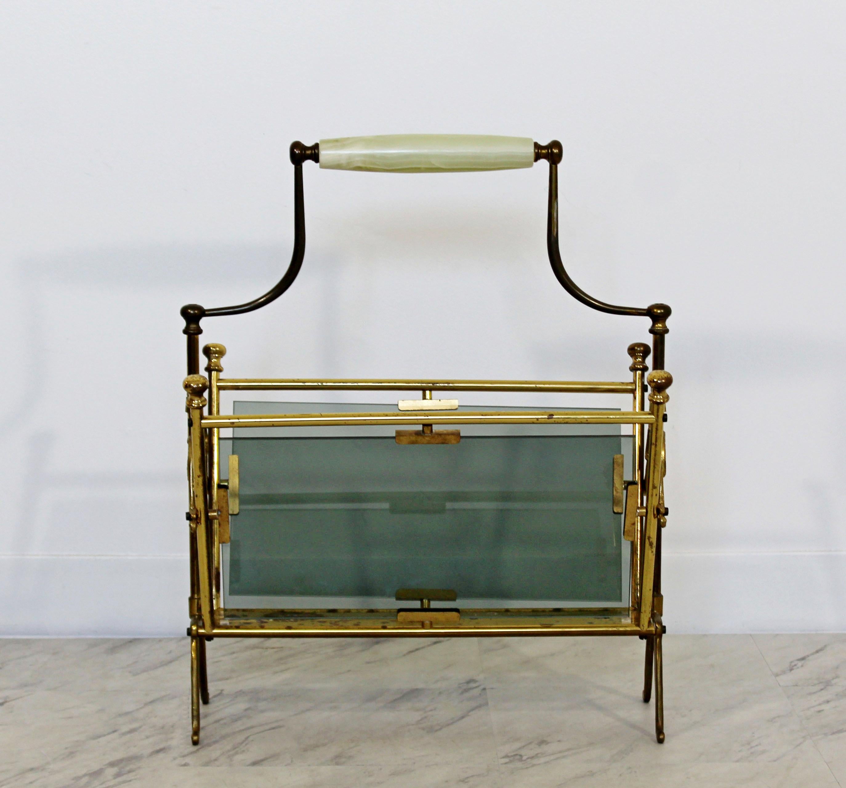 For your consideration is an ornate magazine rack, made of brass, with two smoked glass panels and an opal handle, by Lacca for Fontana Arte, circa the 1950s. In good vintage condition, with a patina to match the age. The dimensions are 18