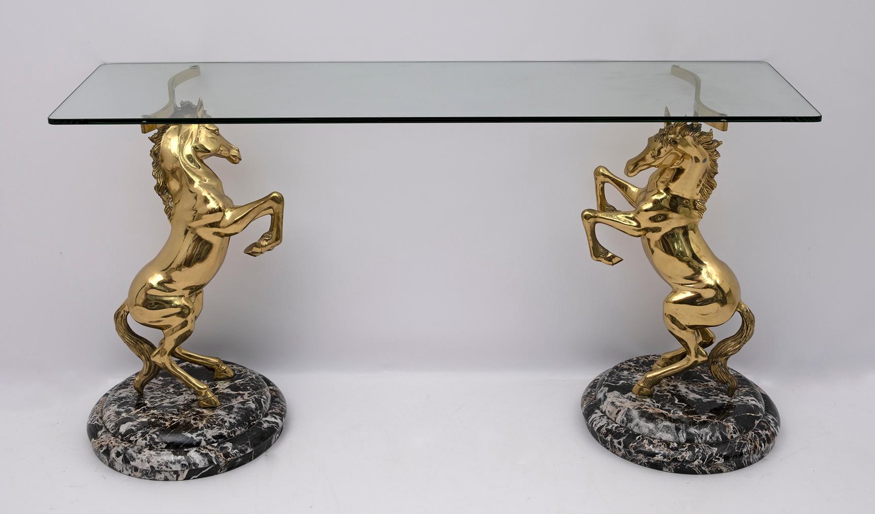 Beautiful console table depicting sculptures of a pair of rampant horses in solid brass, the bases are in black marble and the top in thick glass. Italian production of the 70s.
It is possible to replace the glass top, obtaining a smaller or larger