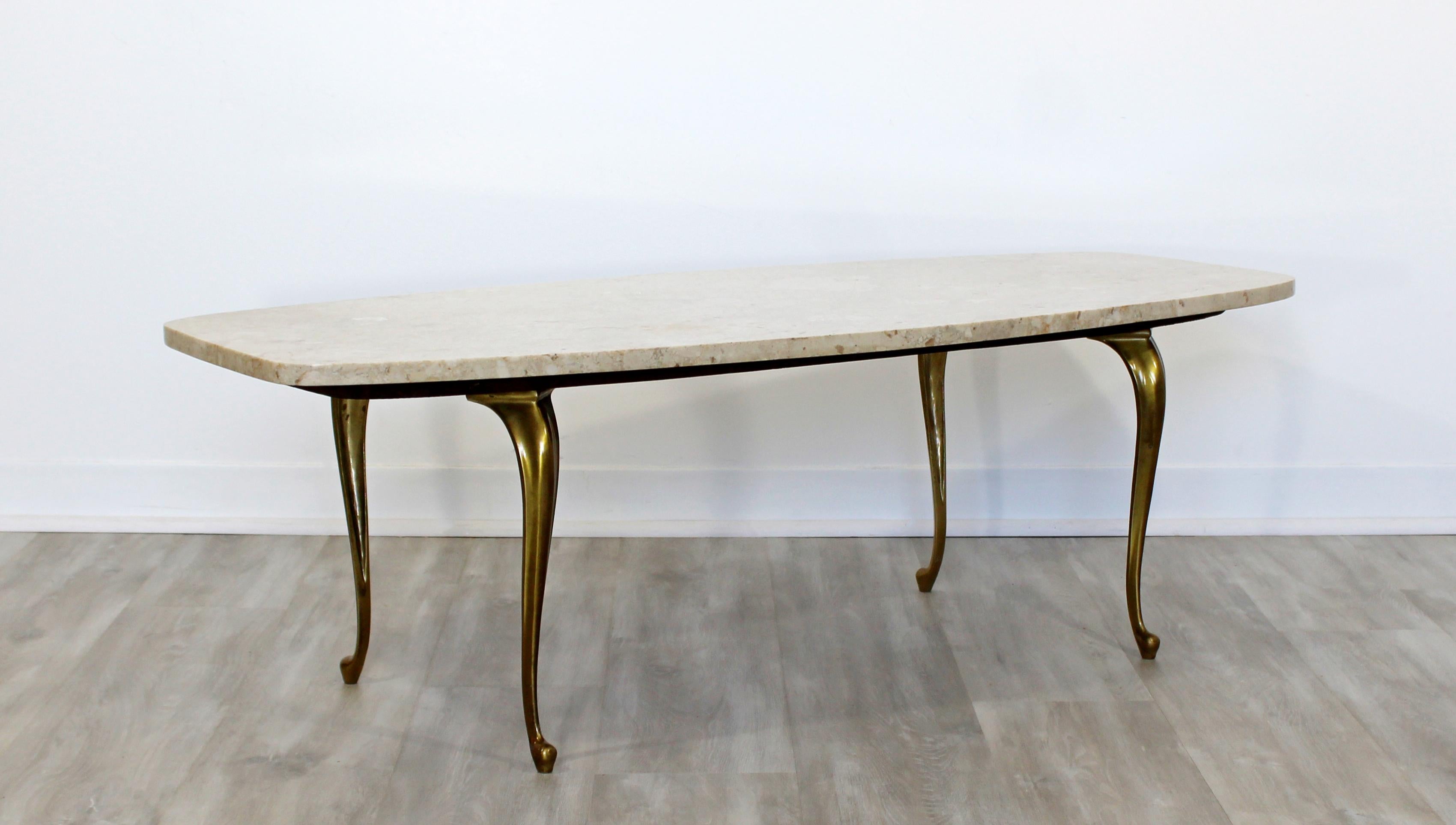 For your consideration is a gorgeous, marble topped coffee table on brass legs, circa the 1960s. In very good vintage condition. The dimensions are 49