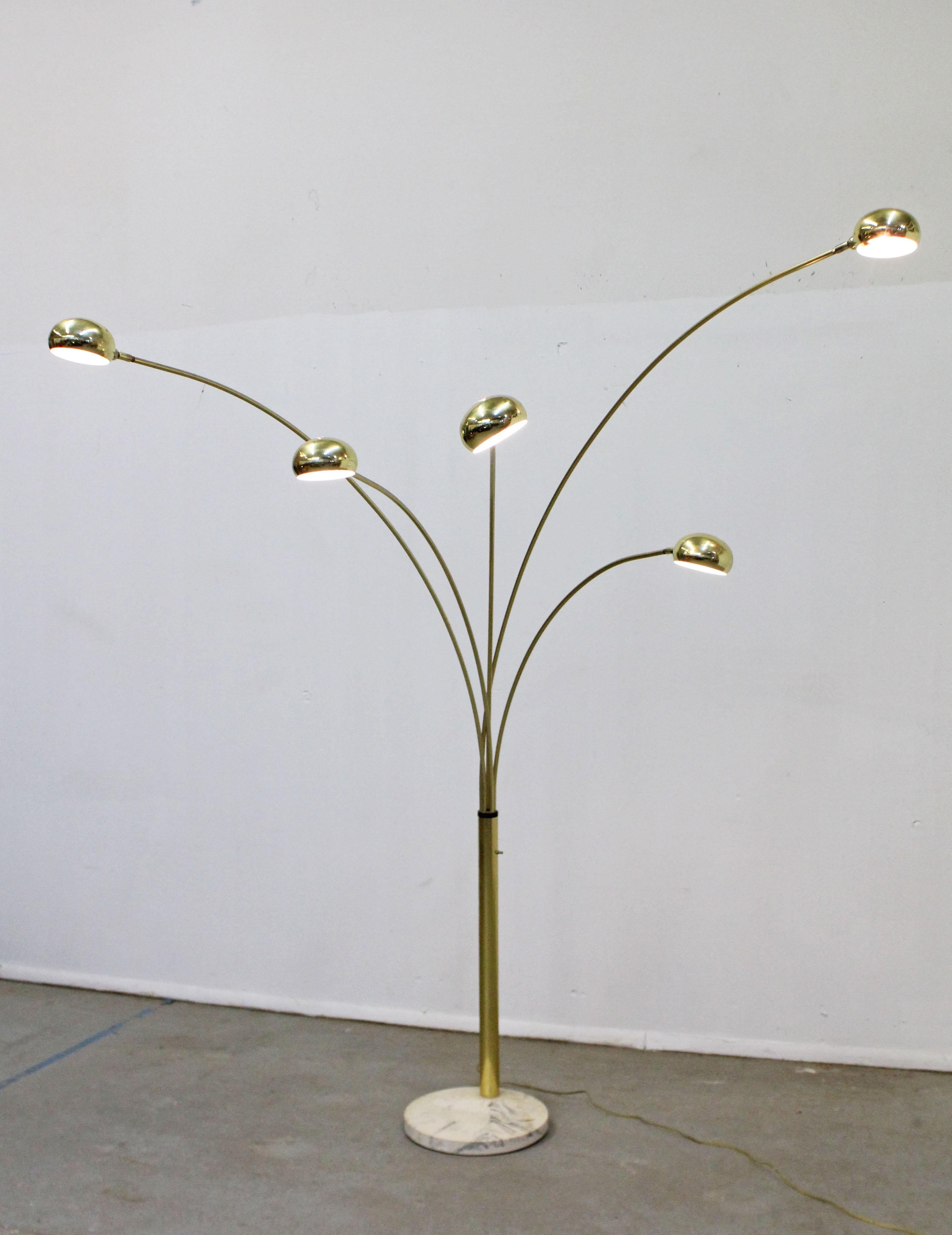 Offered is a super unique, vintage Italian brass and marble floor lamp.  Features a marble base with 5 arc-shaped brass swiveling rods and 5 bulbs that pivot. The heads swivel from left to right and the pivot. The arms swivel about 180 degrees, not