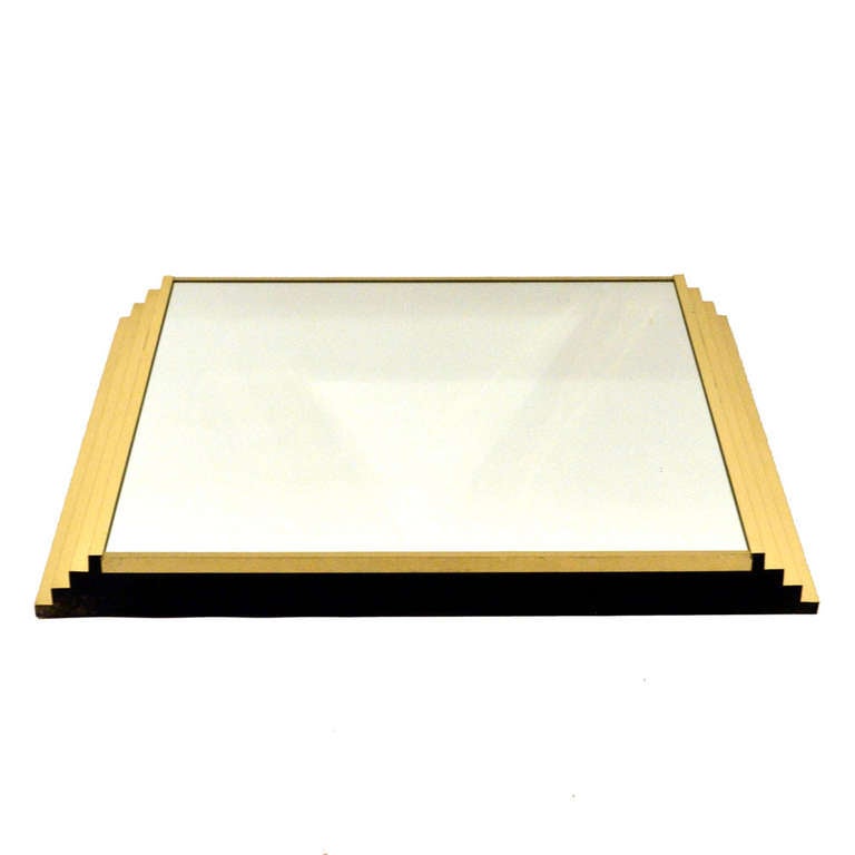 Rectangular wall mirror with descending steps at the sides in brass is Italian 1970's. Ideal over a console or fireplace.