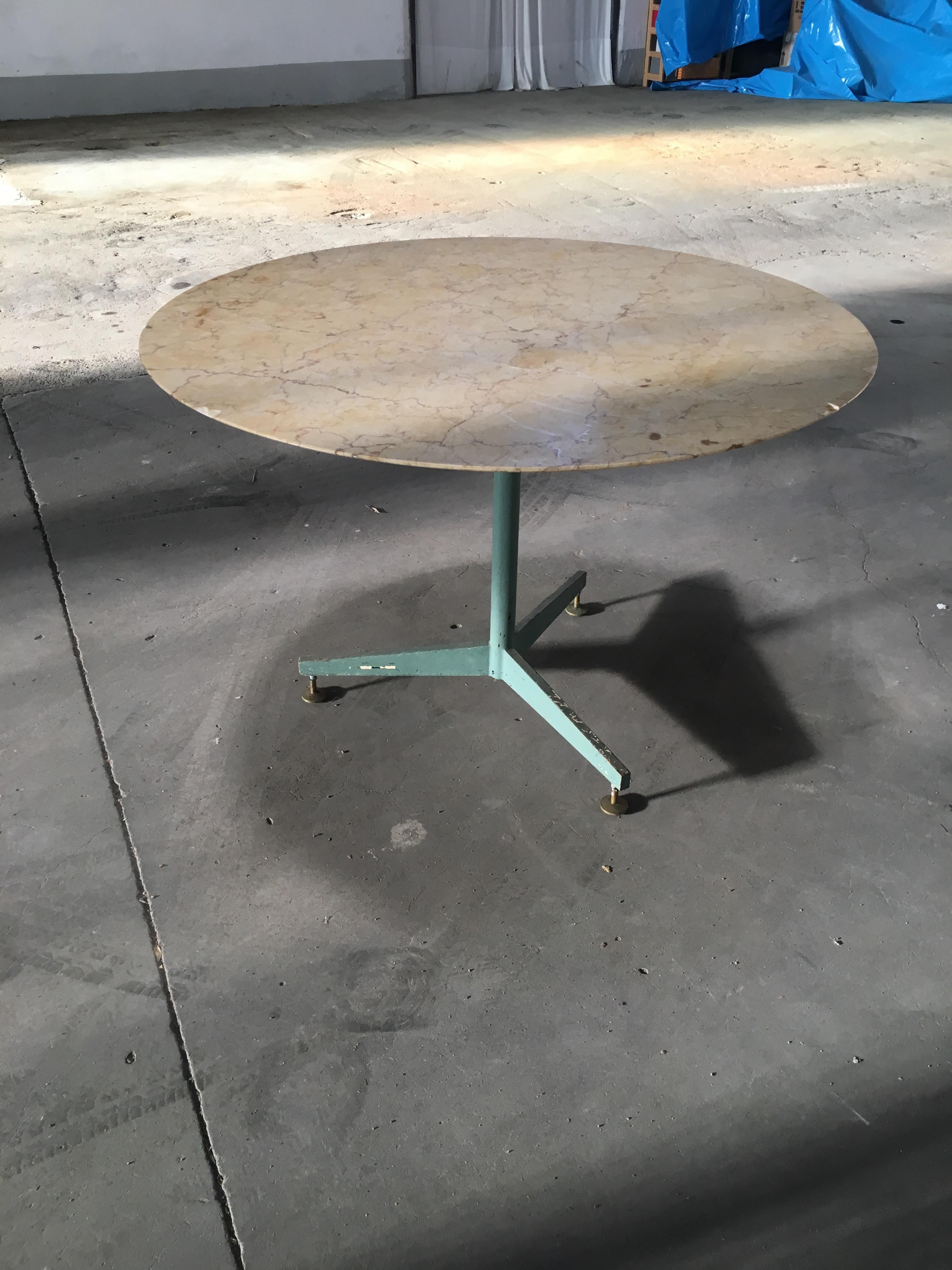 Mid-Century Modern Italian yellow marble top round table with lacquered iron base and brass feet. 1960s.