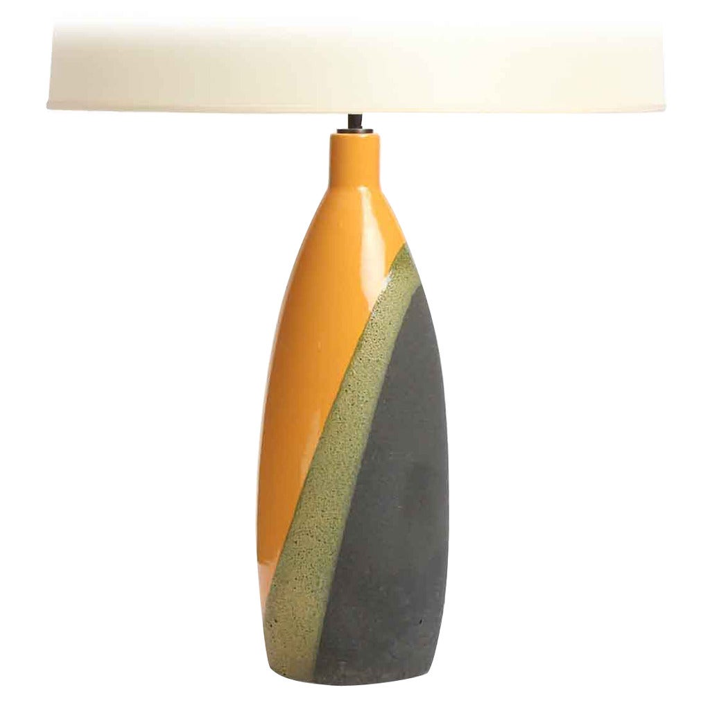 A Mid-Century Modern hand-thrown ceramic table lamp glazed in orange / green / grey with masterful diagonally-biased overlays. Produced in Italy, circa 1960s.
