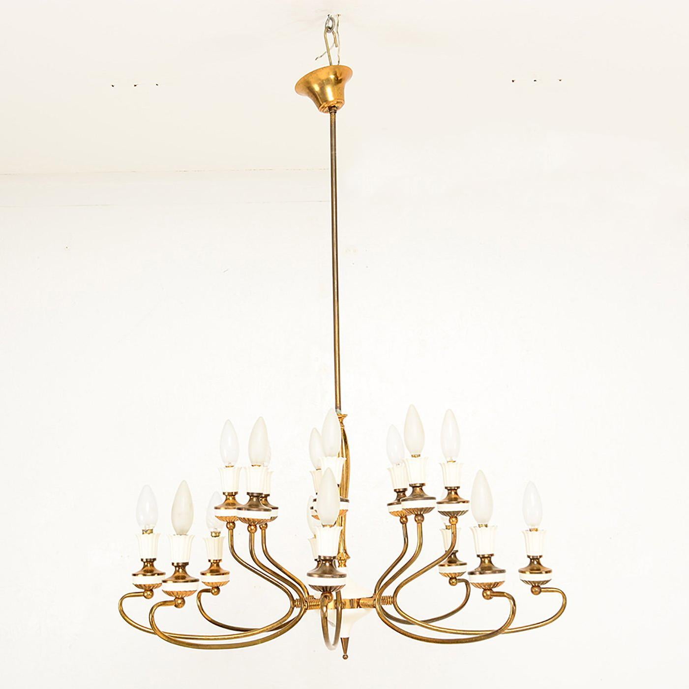 For your consideration a vintage Italian chandelier, two tiers with eight bulbs per tier. Total of 16 bulbs (E-14).

Brass sculptural body frame with original vintage patina.
Aluminum shades in off-white paint. 
Rewired. Bulbs not included.