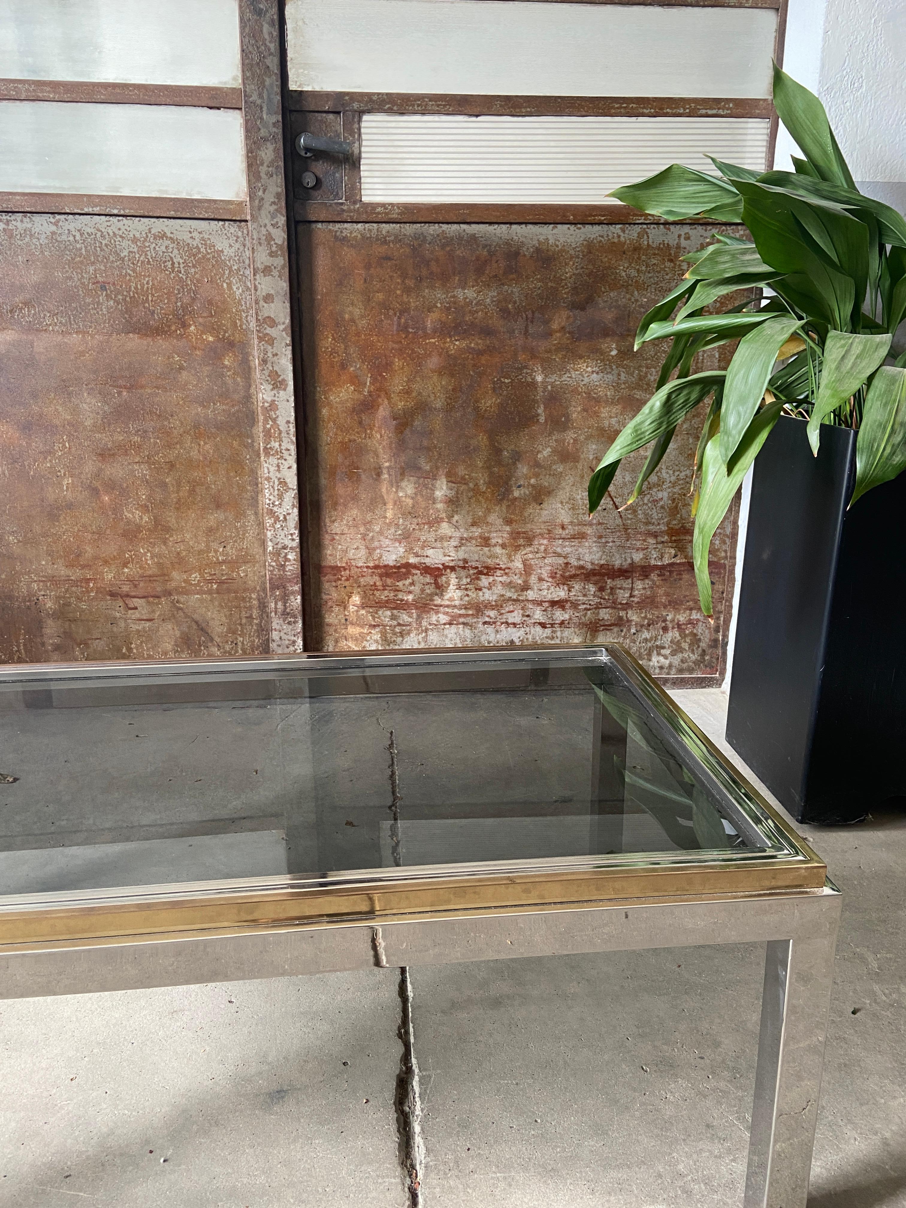 Mid-Century Modern Italian cffee or sofa table by Romeo Rega with brass and chrome structure and smoked glass top.