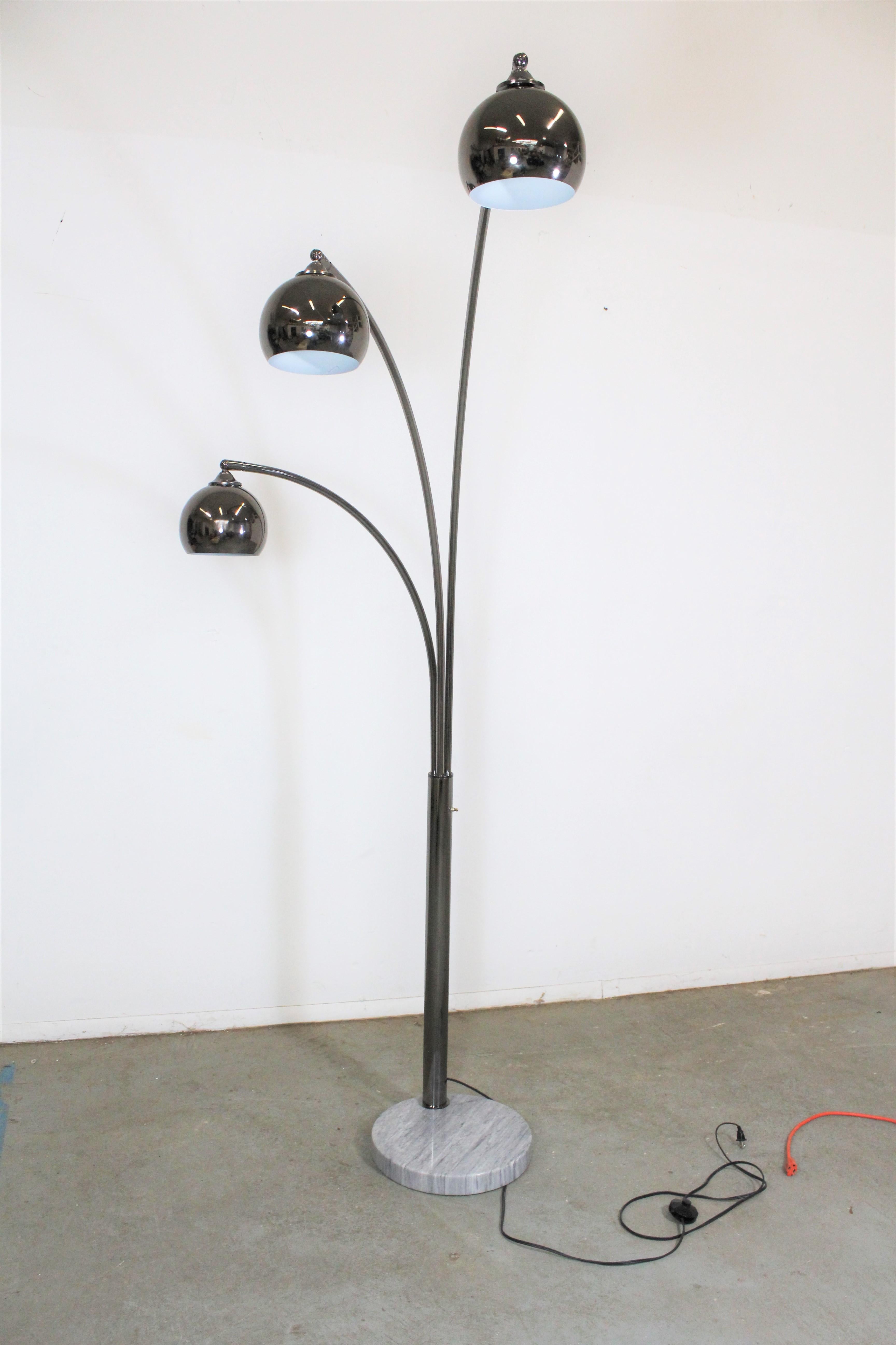Offered is a super unique, vintage Italian chrome and marble floor lamp. Features a marble base with 3 arc-shaped chrome swiveling rods and 3 bulbs that pivot. The heads swivel from left to right and the pivot. The arms swivel about 180 degrees, not