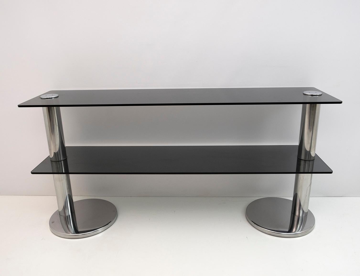 Italian console in smoked glass and steel, 1970s.
Chromed steel structure, with two round pedestals and two smoked glass tops.