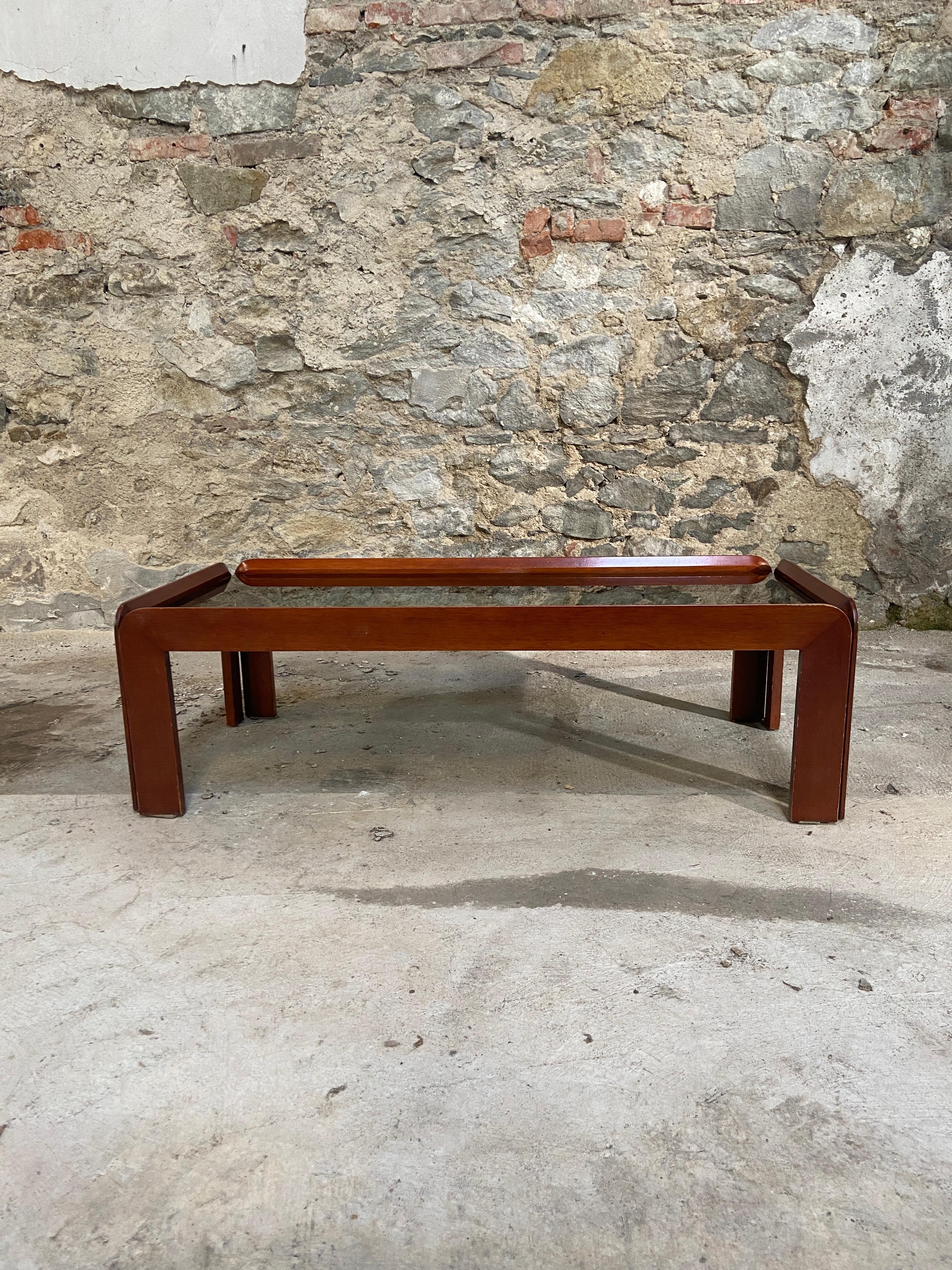 Mid-Century Modern Italian mahogany coffee or sofa table with Smoked Glass Top by Afra & Tobia Scarpa for Cassina.
The table is in really good vintage conditions. The Glass top has no scratches and the solid wood base presents some light wear