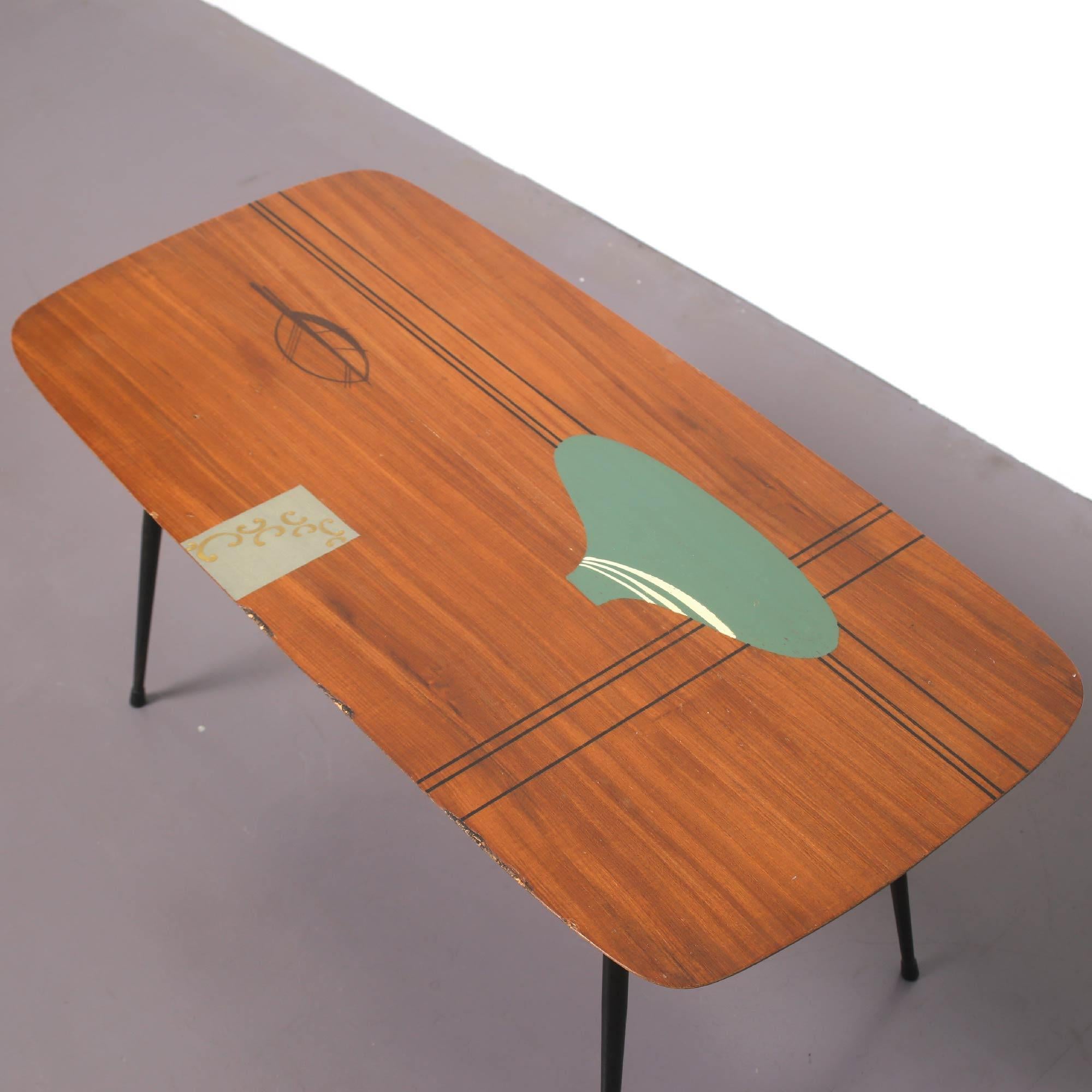 Midcentury coffee table in teak with unique artwork in midcentury style.
The table is in very good conditions and very well presented.