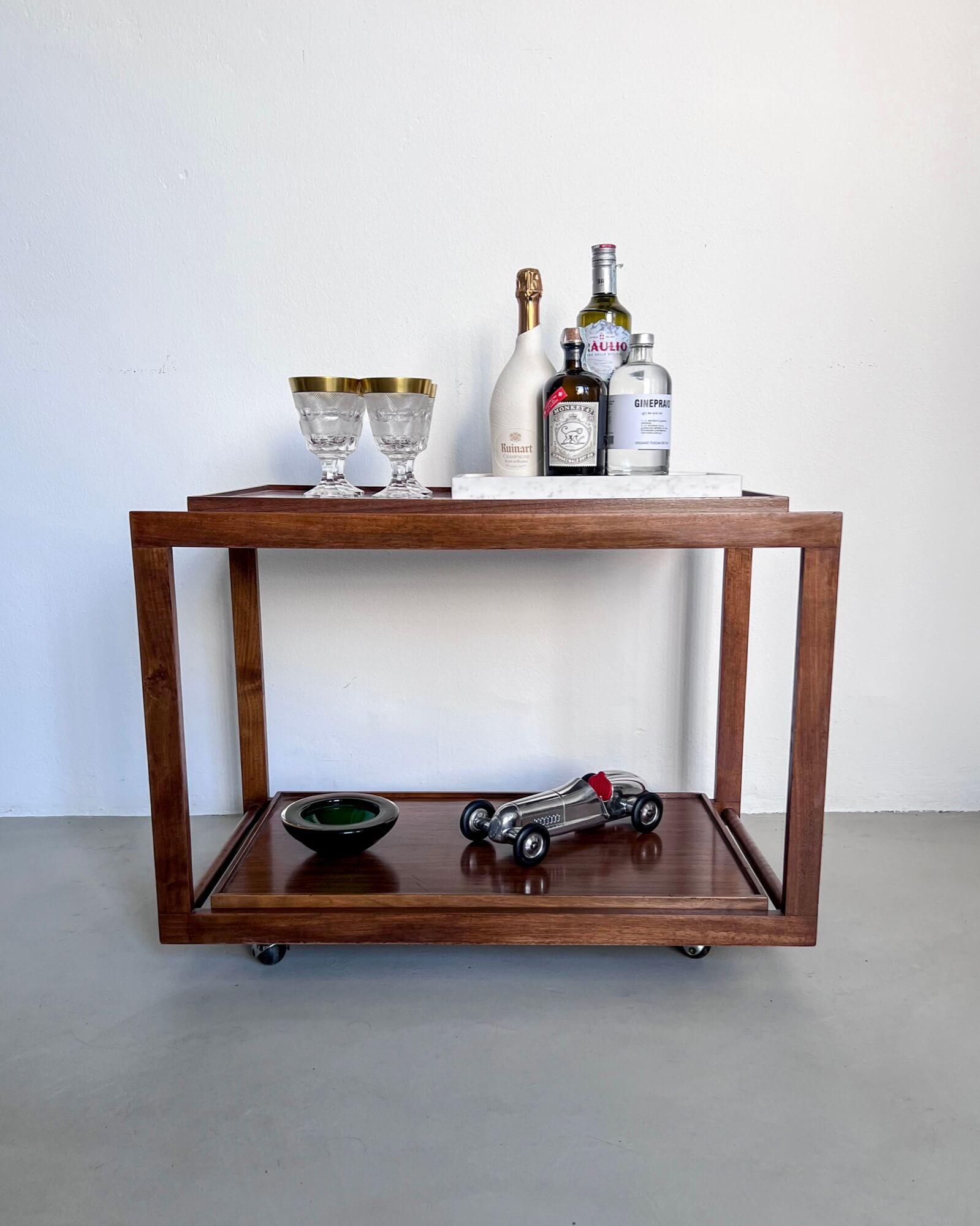 Vintage Bar Cart - Trolley - Mid century design 

Designed by Salvati and Tresoldi for the Italian furniture giant, the cart is absolutely essential - better, rational - in its simple geometric wood frame. But, behold, its two shelves can be easily