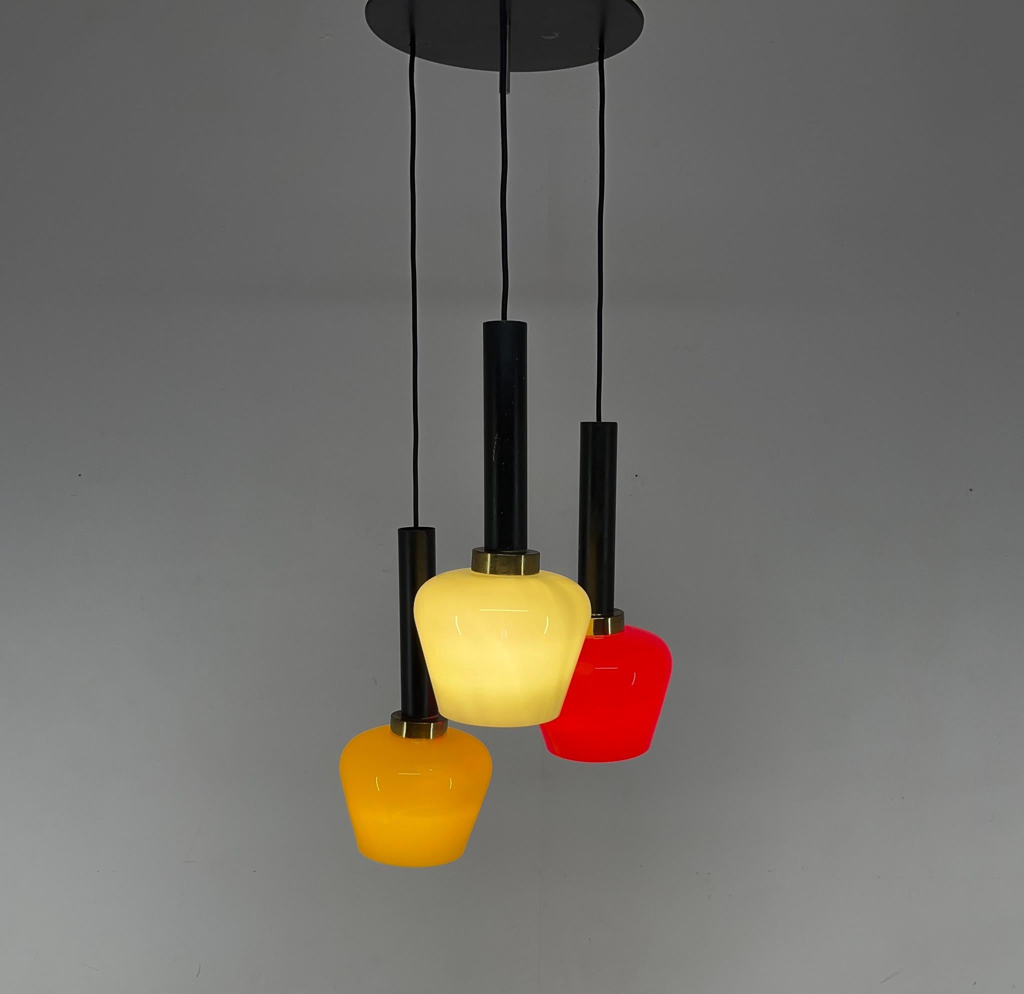 Beautiful coloured pendant lamp with red, green and yellow Murano glass shades. Each shade has a brass ring with a metal tube at the top. The adjustable cords are suspended from a metal plate. Rewired. Bulbs: 3x E25-E27.