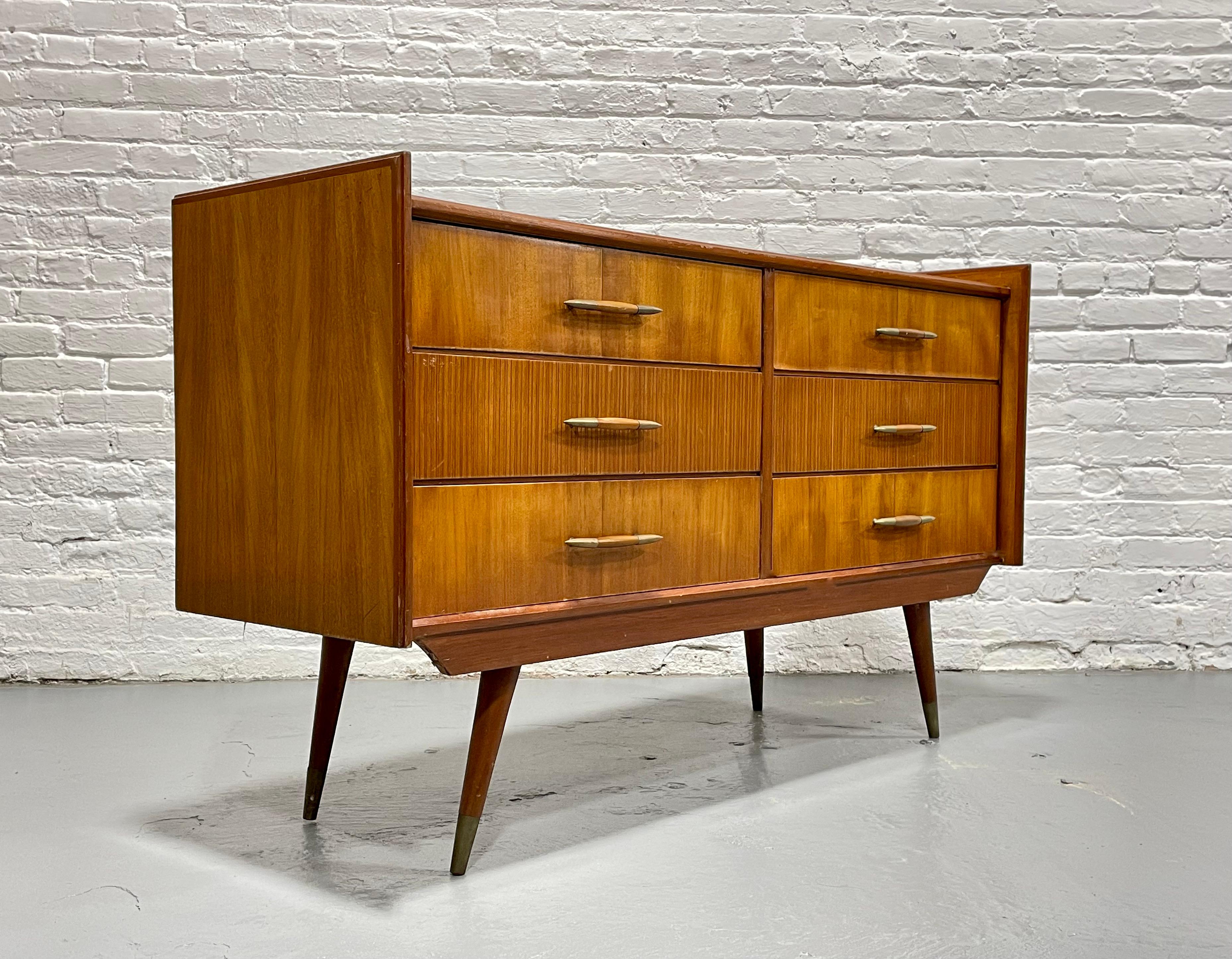Truly Incredible Mid Century Modern Six Drawer Long Dresser, c. 1950’s. A rare example of Italian Mid Century Modern design with lovely butterscotch coloring. This finely crafted dresser features the most incredible wood grains and gorgeous long