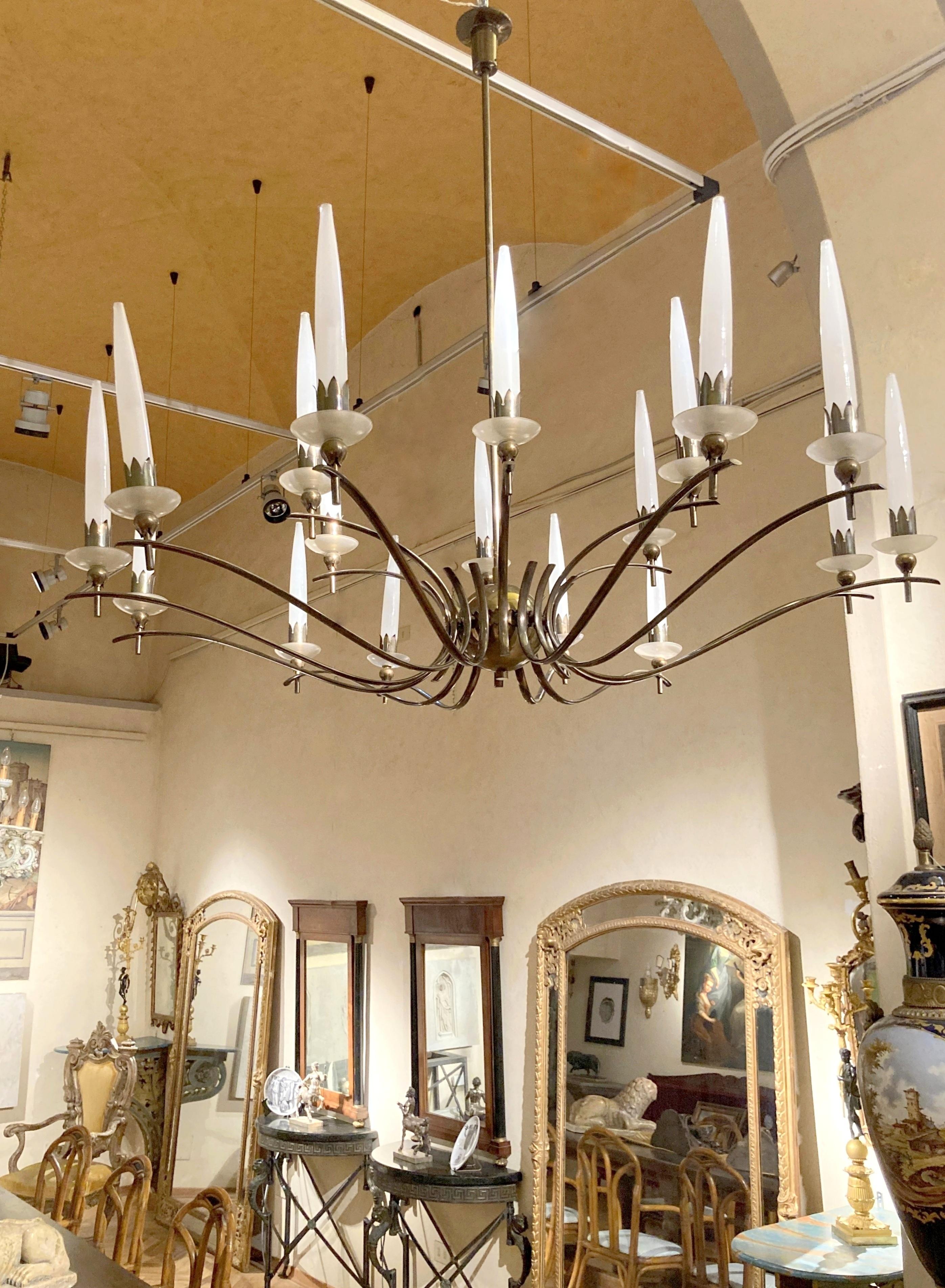 An impressive eighteen-arm chandelier made of smoked brass with frosted murano glass lampshades attributed to Angelo Lelli, a rare iconic Mid Century Modern Italian design pendant with wonderful curved shape and beautiful decorative detailing