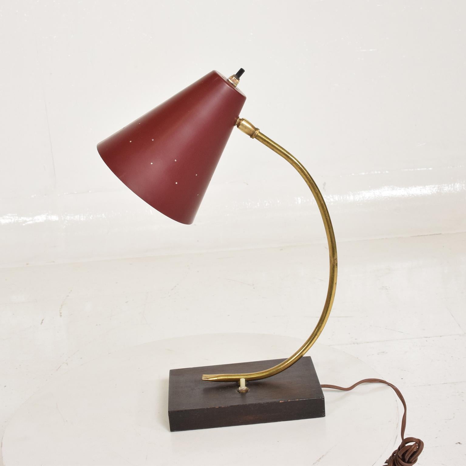 For your consideration, a Mid-Century Modern Italian desk task lamp.

Unmarked, red shade with wood base and brass sculptural body. Tested and working. 

Dimensions:

16