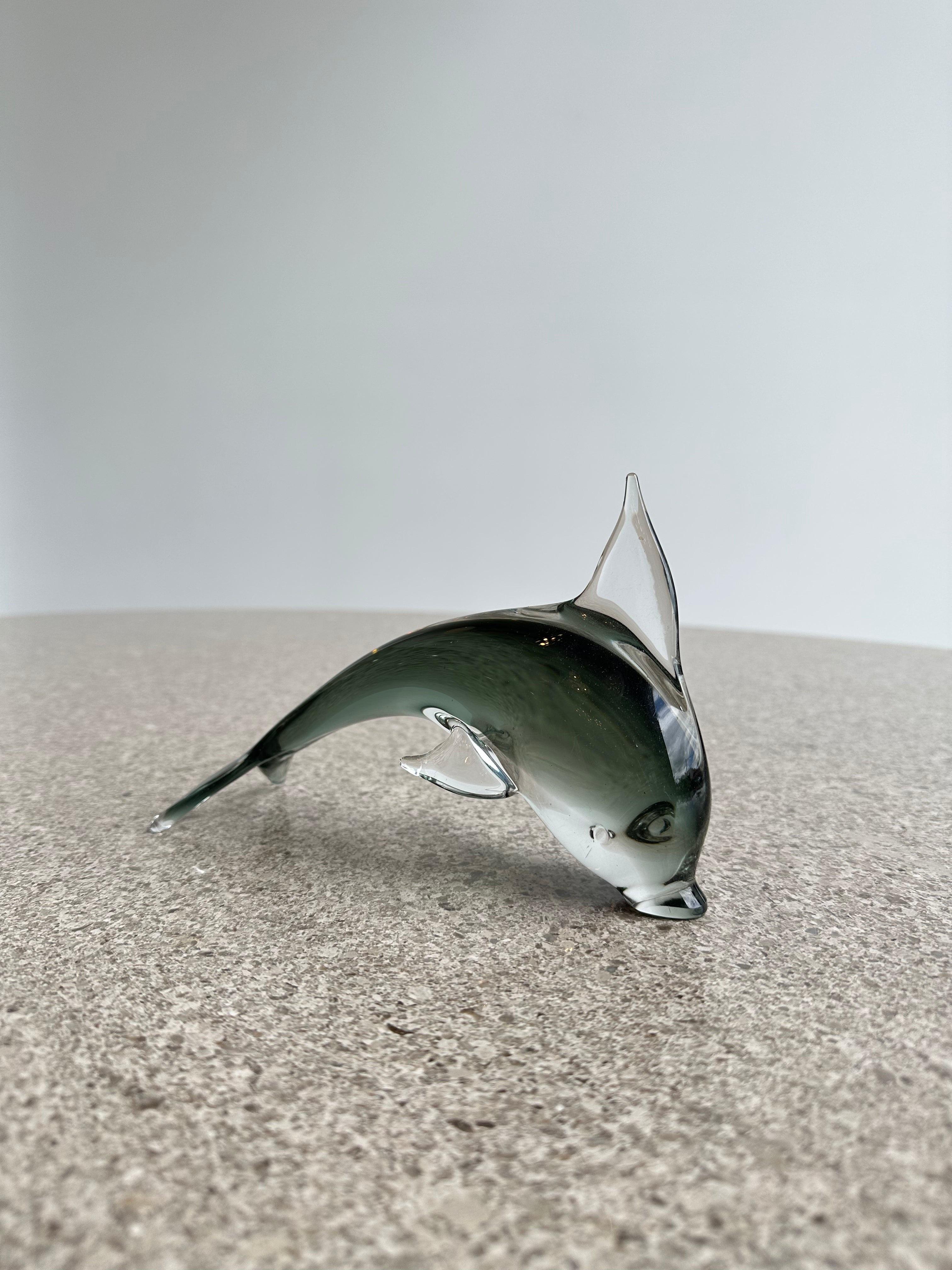 Murano smoked glass dolphin table sculpture, unique addition to any home or office decor. Murano glass fish sculptures are known for their vibrant colors, intricate details, and lifelike shapes.


Manufacturer: Murano
Place of Origin: Italy 
Date of