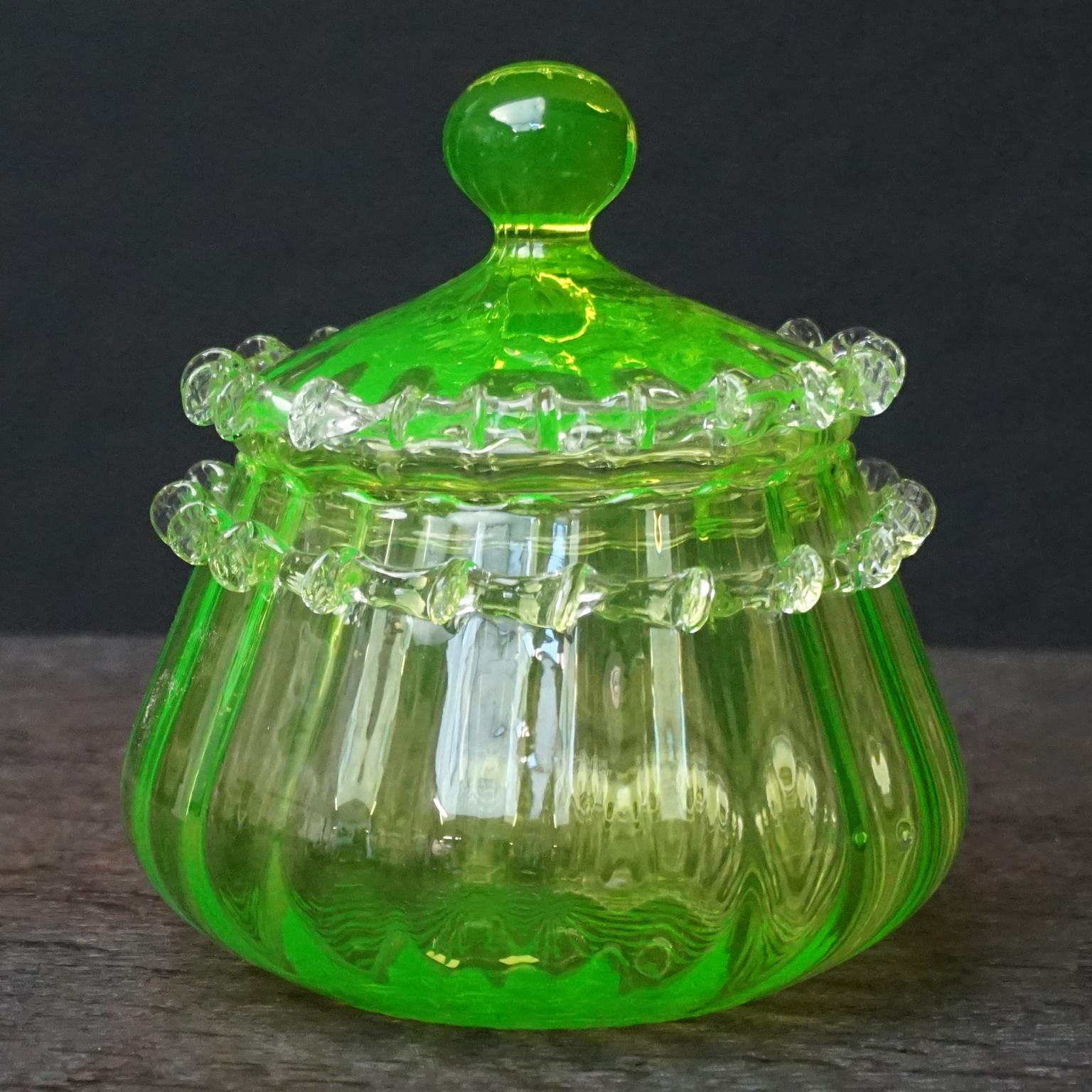 Very rare and pretty little MCM 1950s Italian Empoli candy or apothecary jar in vaseline glass also known as uranium glass.
In bright yellow but in UV-light it turns bright green.

Uranium glass is glass in which small traces uranium, usually in