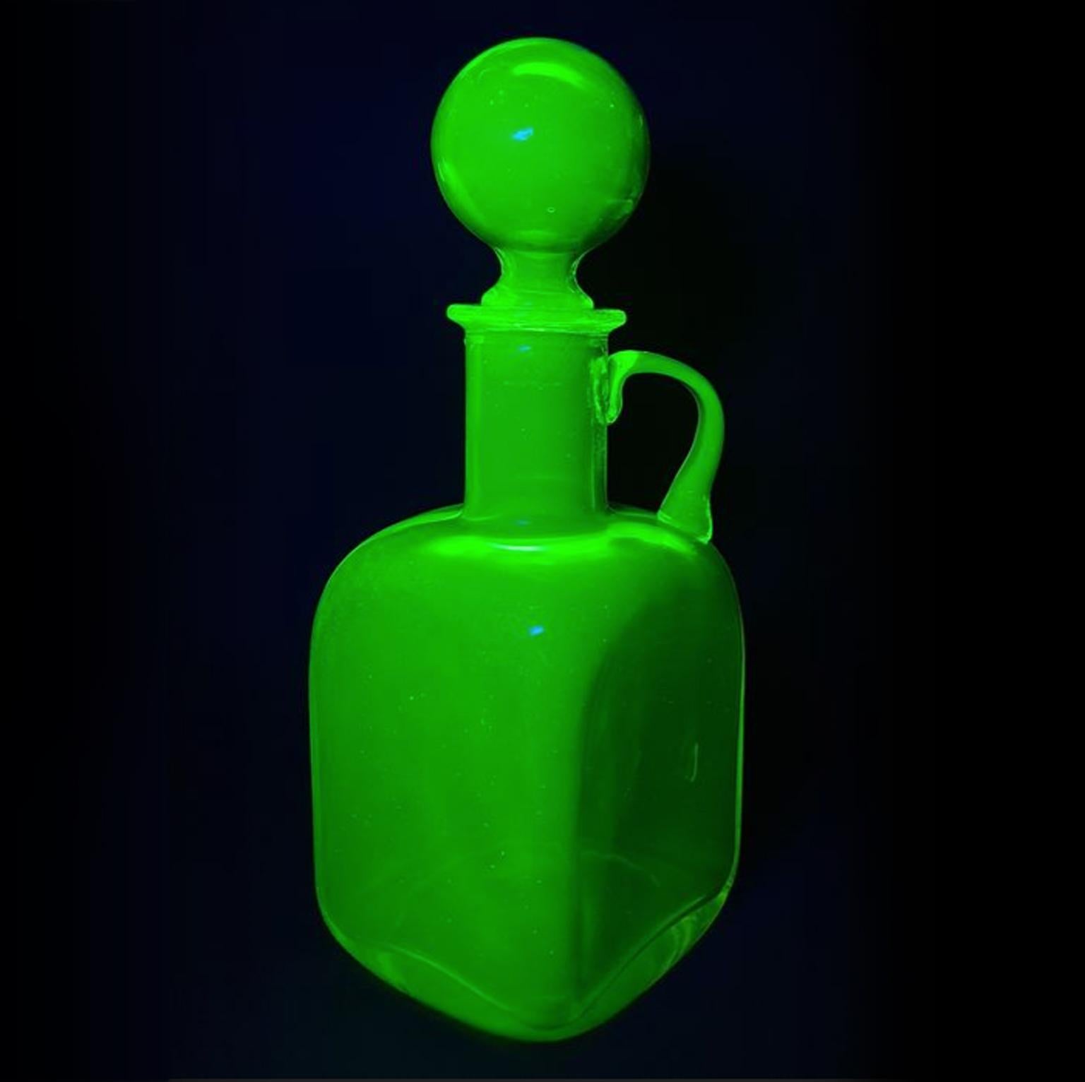 Very rare and pretty MCM 1950s Italian Empoli carafe in vaseline glass also known as uranium glass.
In bright yellow but in UV-light it turns bright green.

Uranium glass is glass in which small traces uranium, usually in oxide diuranate form (a