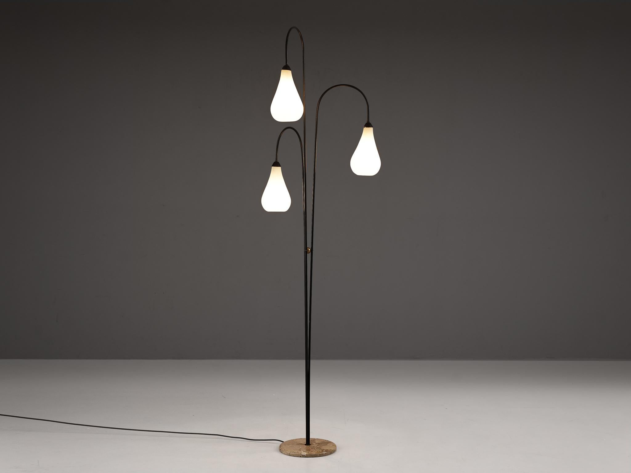 Floor lamp, glass, brass, marble, coated steel, Italy, 1960s 

Made in Italy, this elegant floor lamp features three curved arms each holding a white shade that reminds of water drops. The black coated steel rods are secured to a round marble base