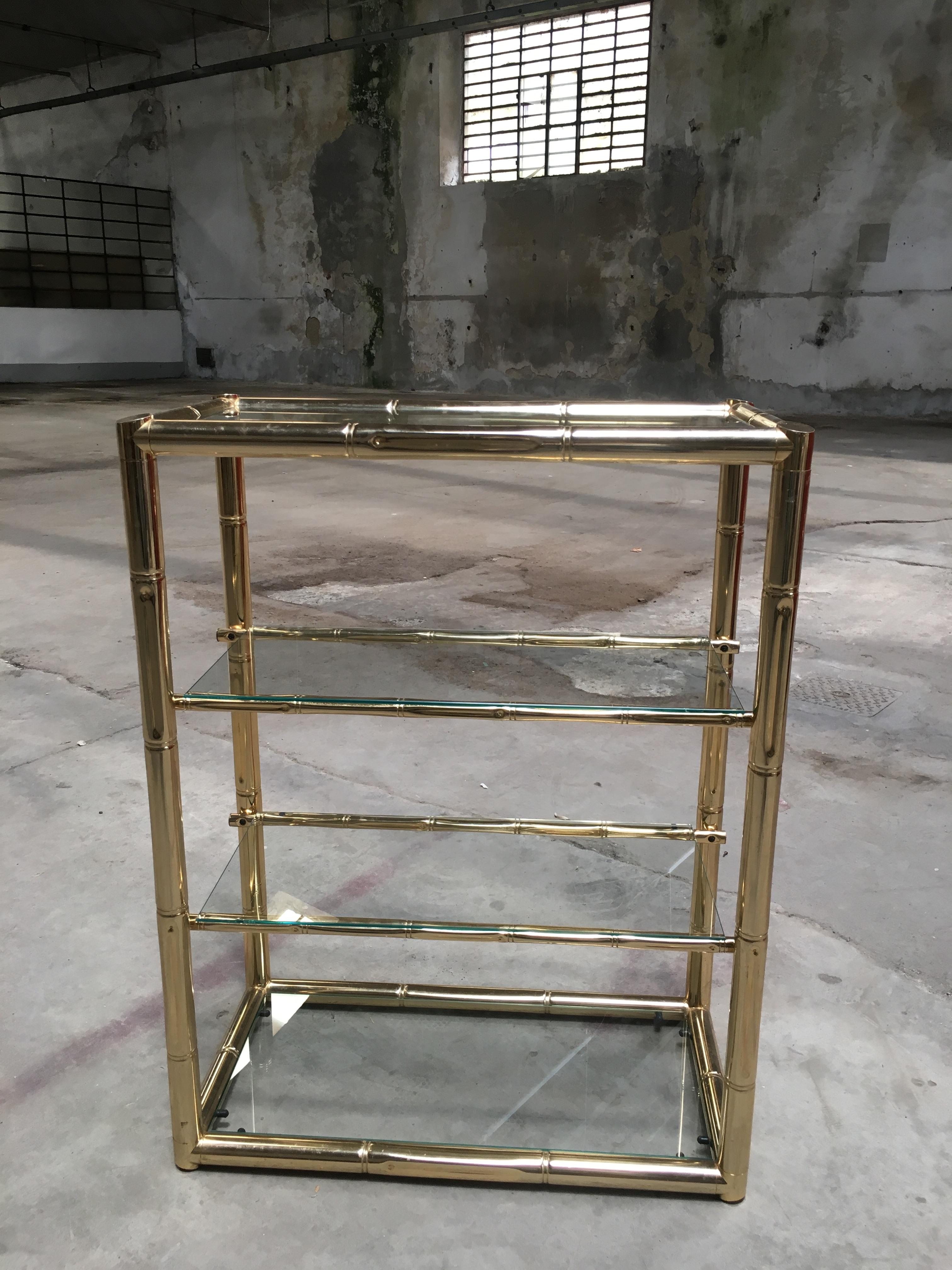 Mid-Century Modern Italian faux bamboo gilt metal and glass étagère from 1970s 
This étagère can come as a set together with a console table and a mirror as shown in the pictures. 
Price for the set on request.