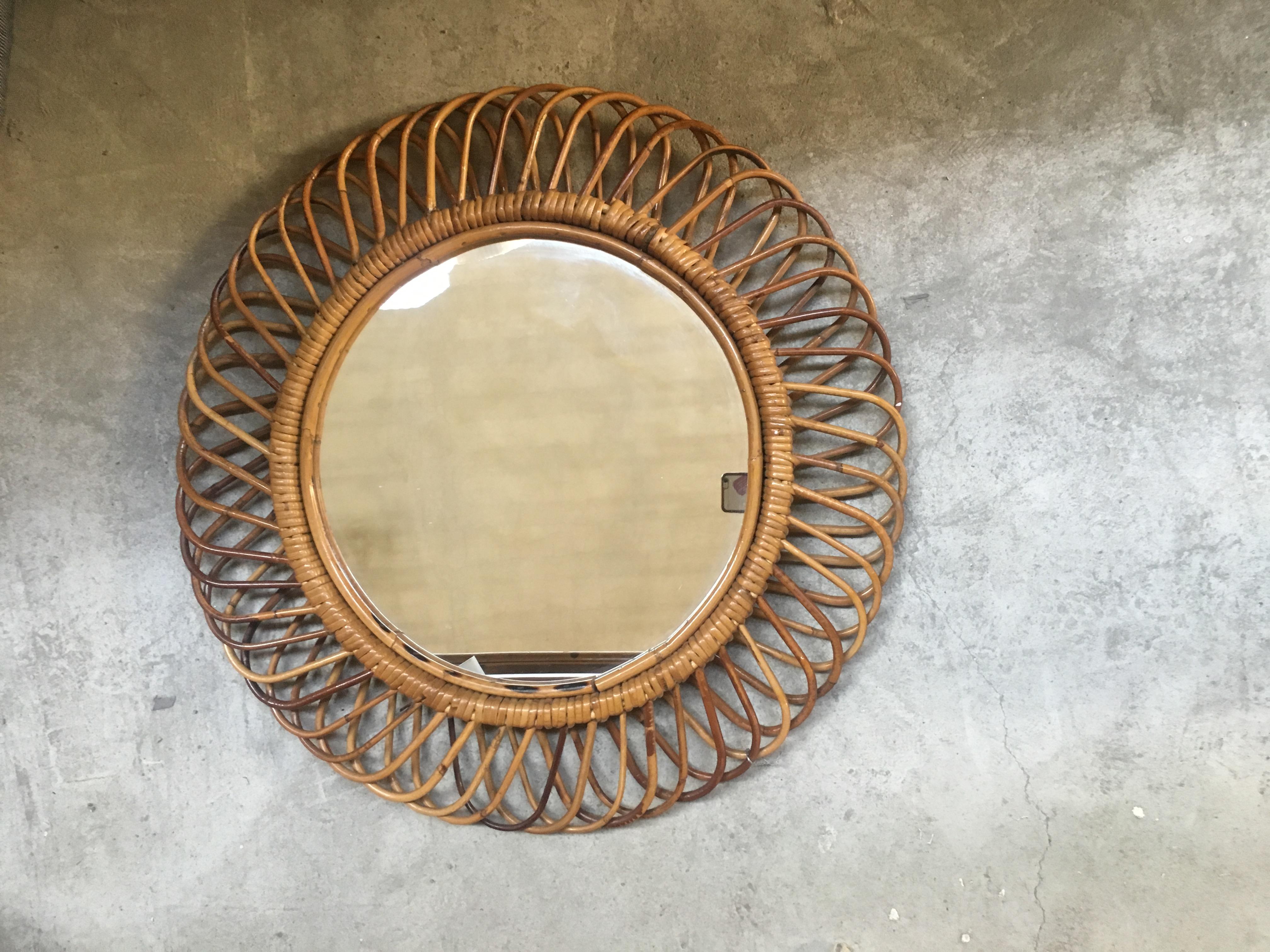 Mid-Century Modern Italian French Riviera Wicker cane sunburst circular wall mirror from 1960s.
The mirror is in very good vintage conditions.
 