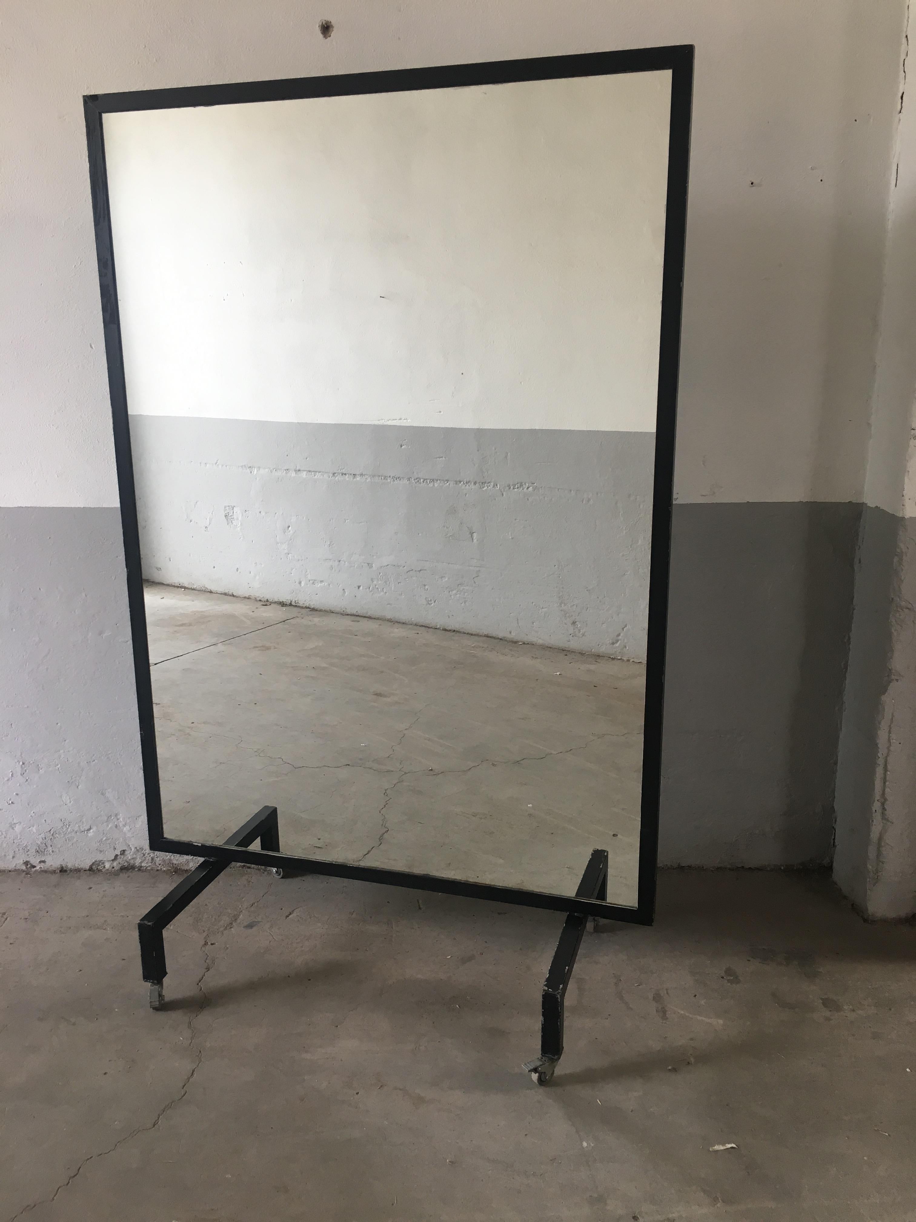 Mid-Century Modern Italian black iron framed full-length free standing large mirror on wheels.
This mirror comes from a ballet school and can be used to embellish any room of your house.