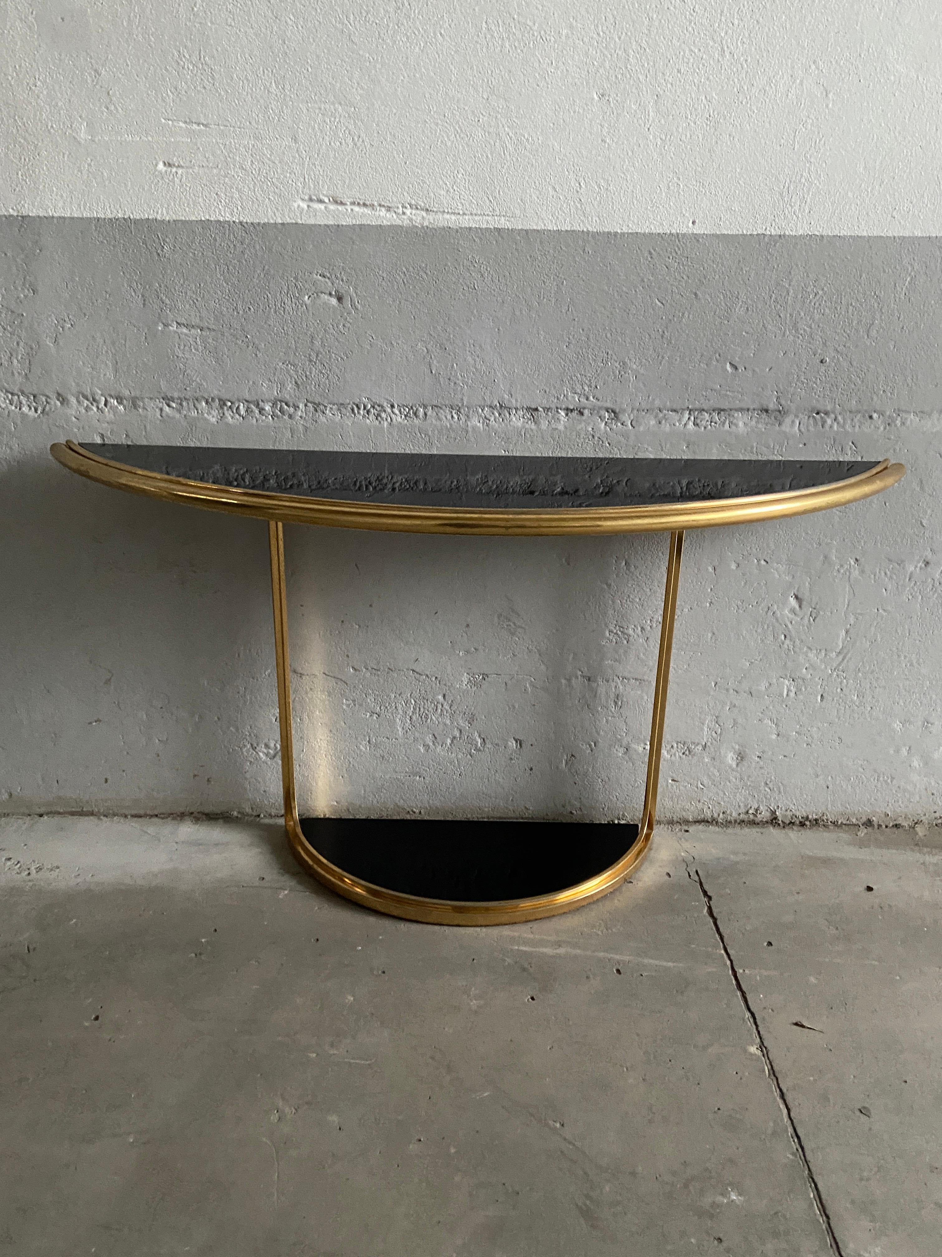 Mid-Century Modern Italian gilt metal console table with black glass top.