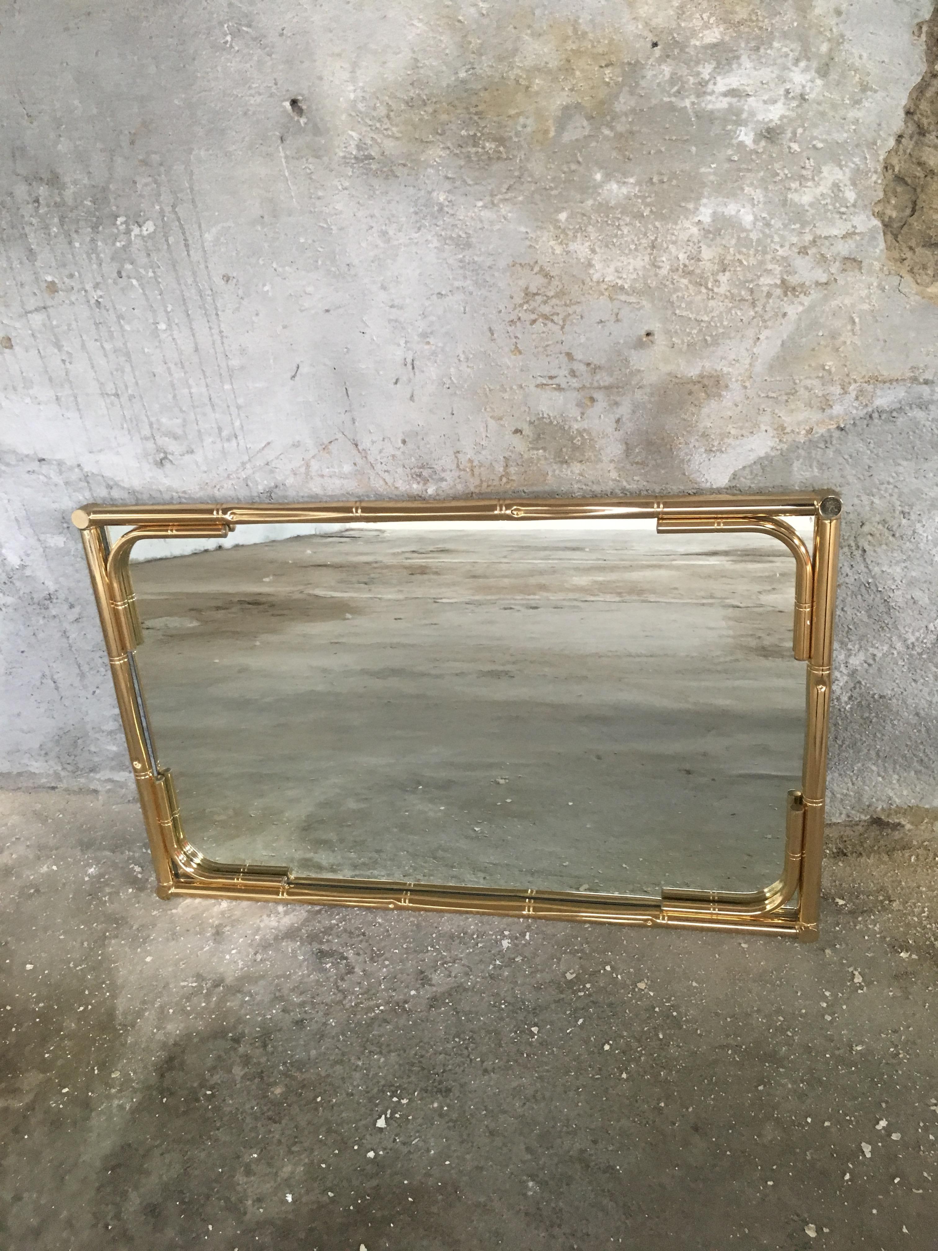 Mid-Century Modern Italian gilt metal faux bamboo framed wall mirror. 
The mirror can be hang both horizontal or vertical 
This mirror can become a set together with its gilt metal faux bamboo console as shown in the photos.

 