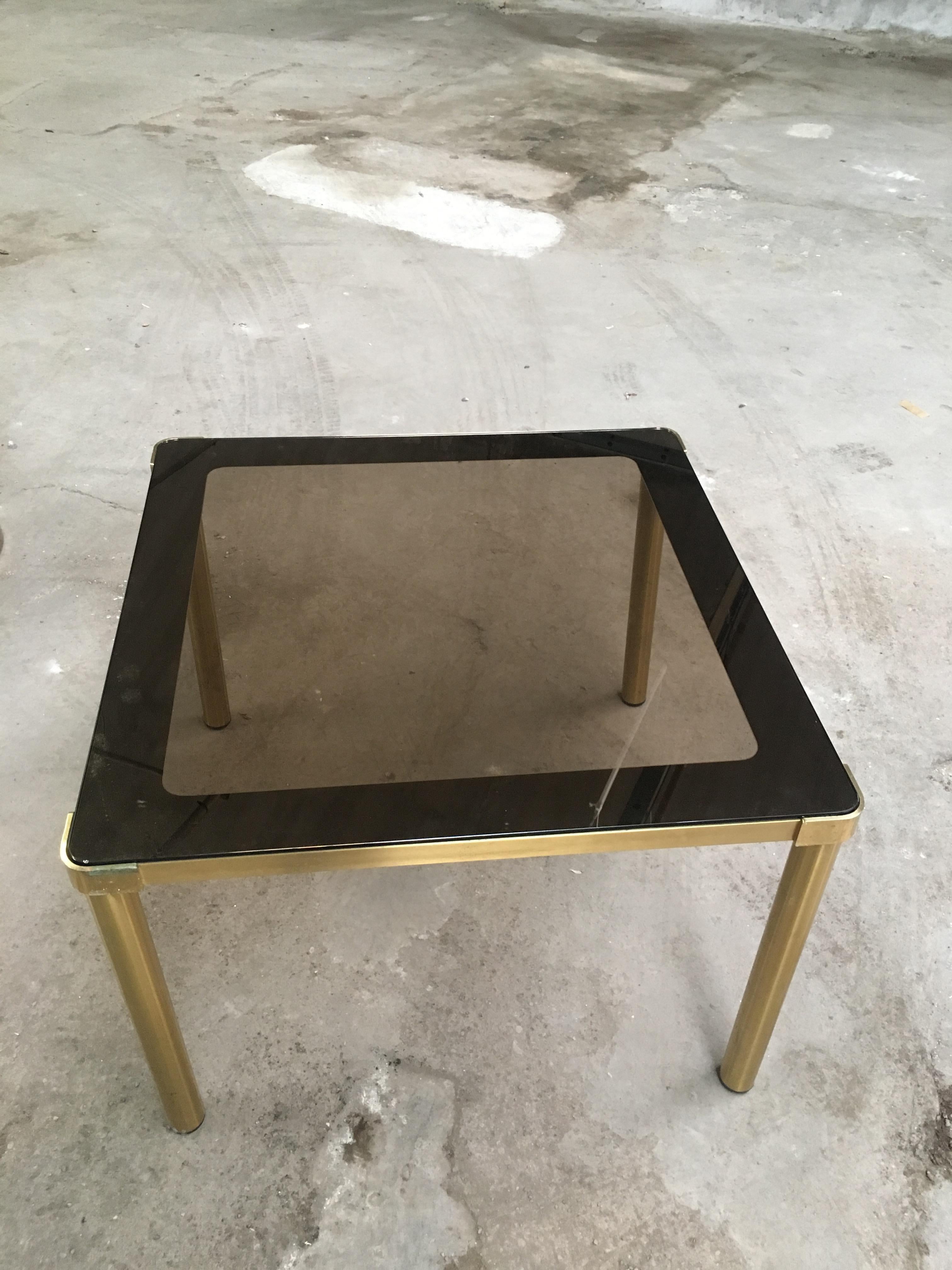 Mid-Century Modern Italian smoked glass top dining or center table with gilt metal frame and legs
The table could be completely disassembled due to the screwed legs.
 
