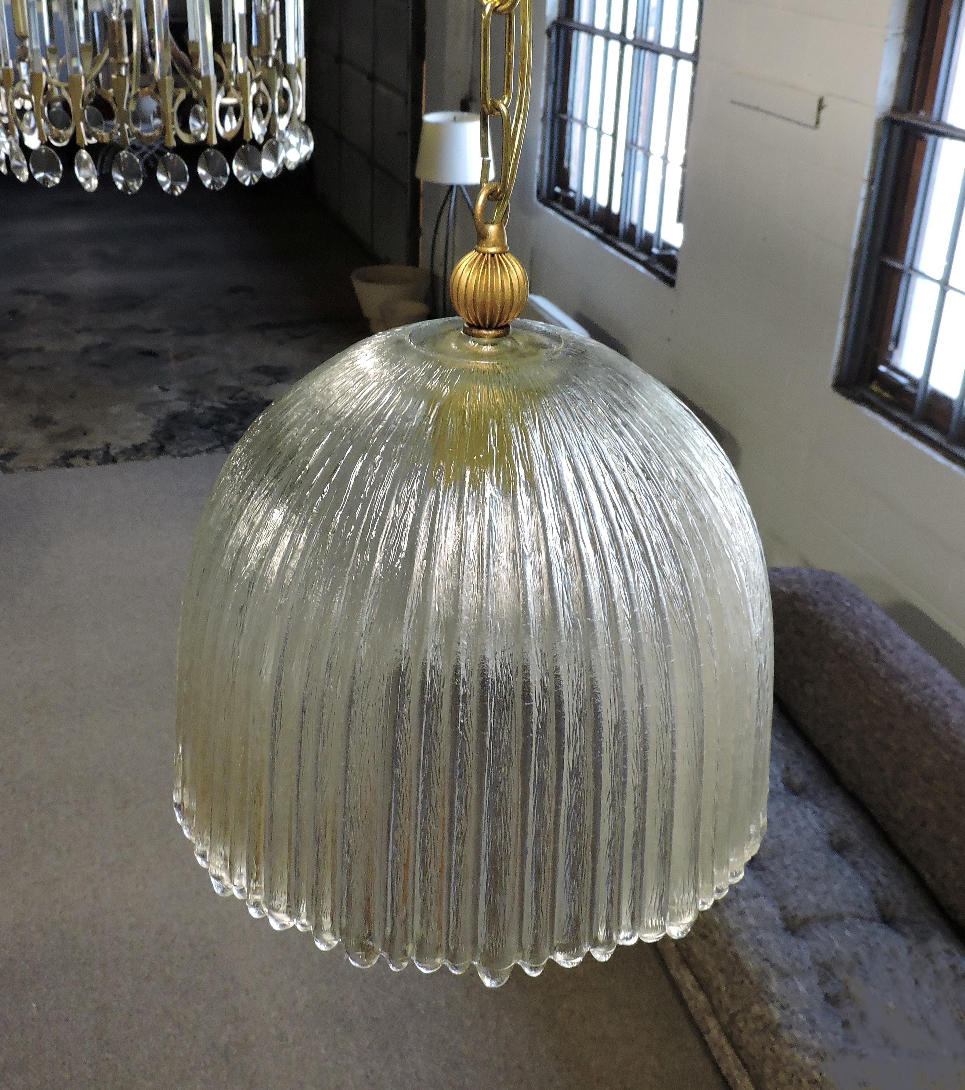 Beautiful Italian glass pendant lamp. This light has a heavy, ribbed and textured dome shade with an uneven edge.