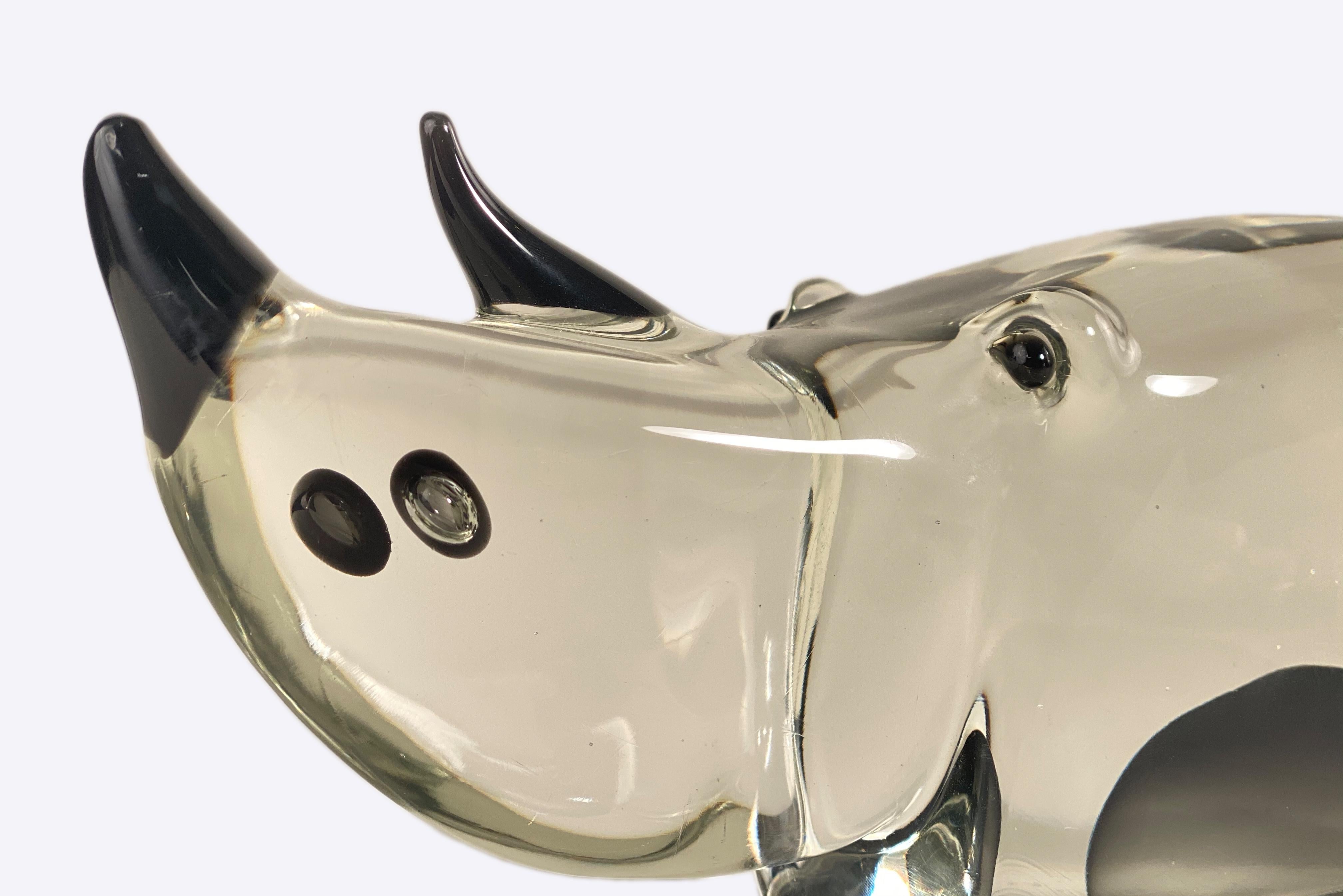 A Mid-Century Modern Italian Glass Rhinoceros part of the Zoo Series designed by, Antonio Da Ros for Gino Cenedese (Cenedese Vetri) & Figlio Glass decorated with black eyes, horn and black sommerso decoration encased in a thick, heavy, clear layers