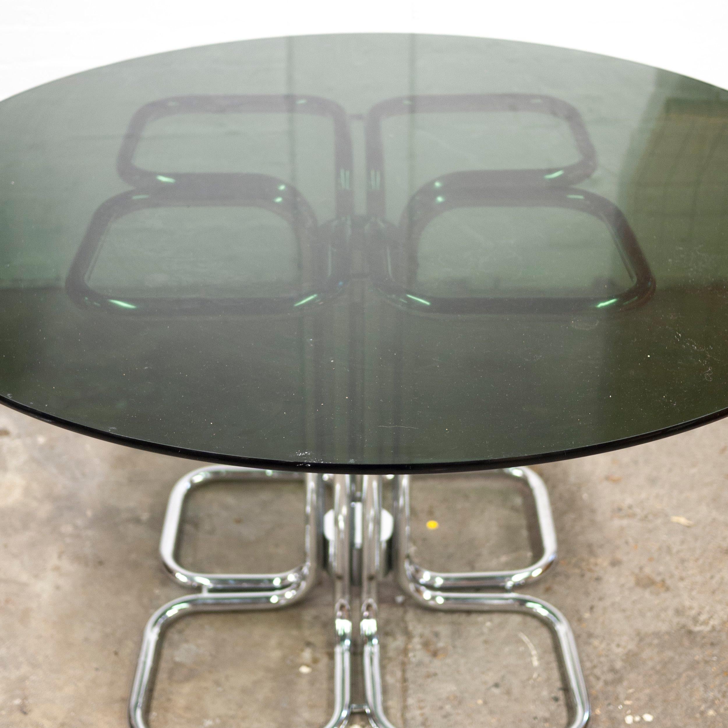 A glass and tubular metal dining table with a pedestal base in the style of hollywood regency.

Designer - Giotto Stoppino

Design Period - 1970 to 1979

Style - Hollywood Regency

Detailed Condition - Good with minimal defects.

Restoration and