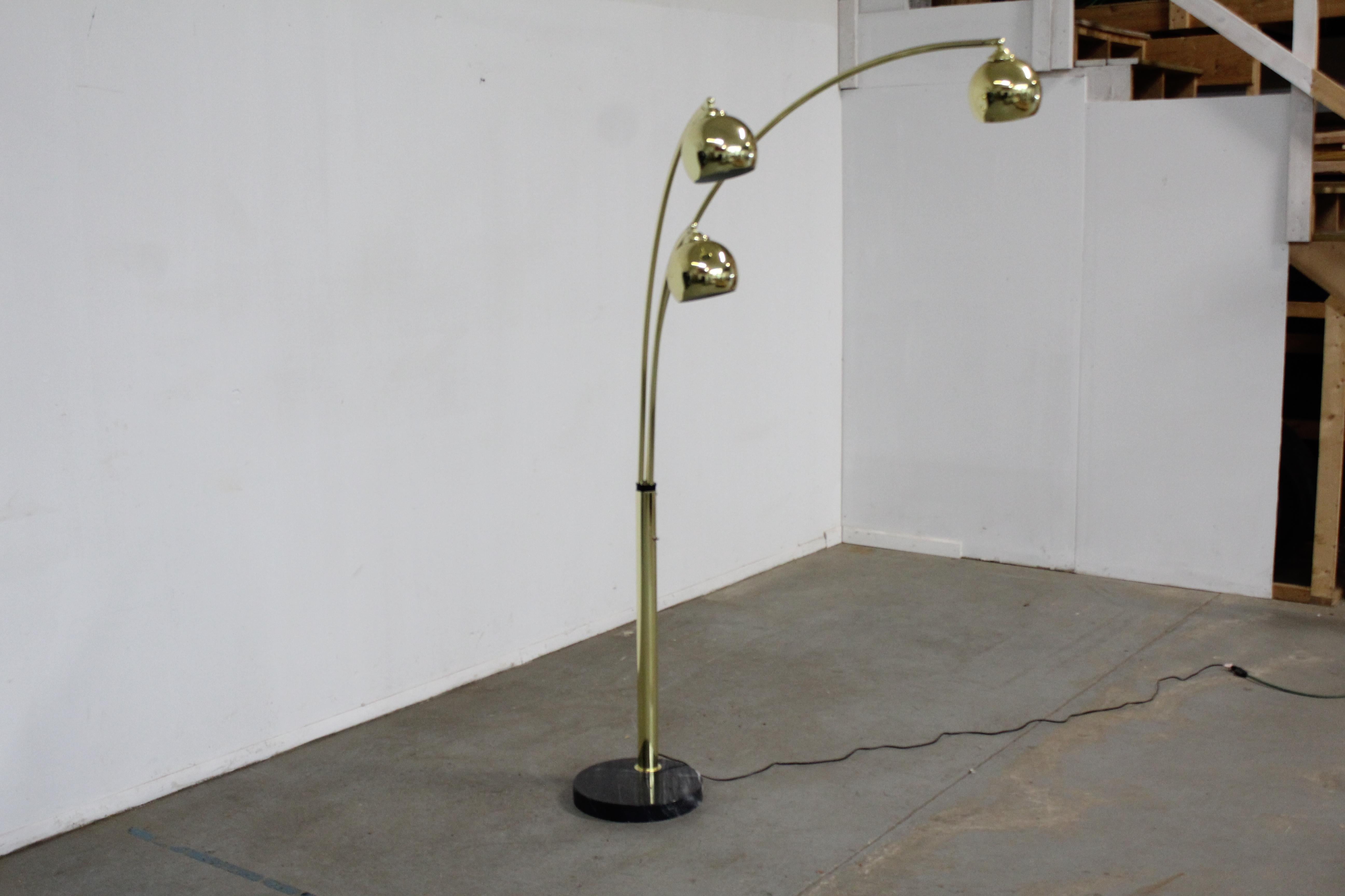 Offered is a super unique, vintage Italian chrome and marble floor lamp. Features a marble base with 3 arc-shaped chrome swiveling rods and 3 bulbs that pivot. The heads swivel from left to right and the pivot. The arms swivel about 180 degrees, not