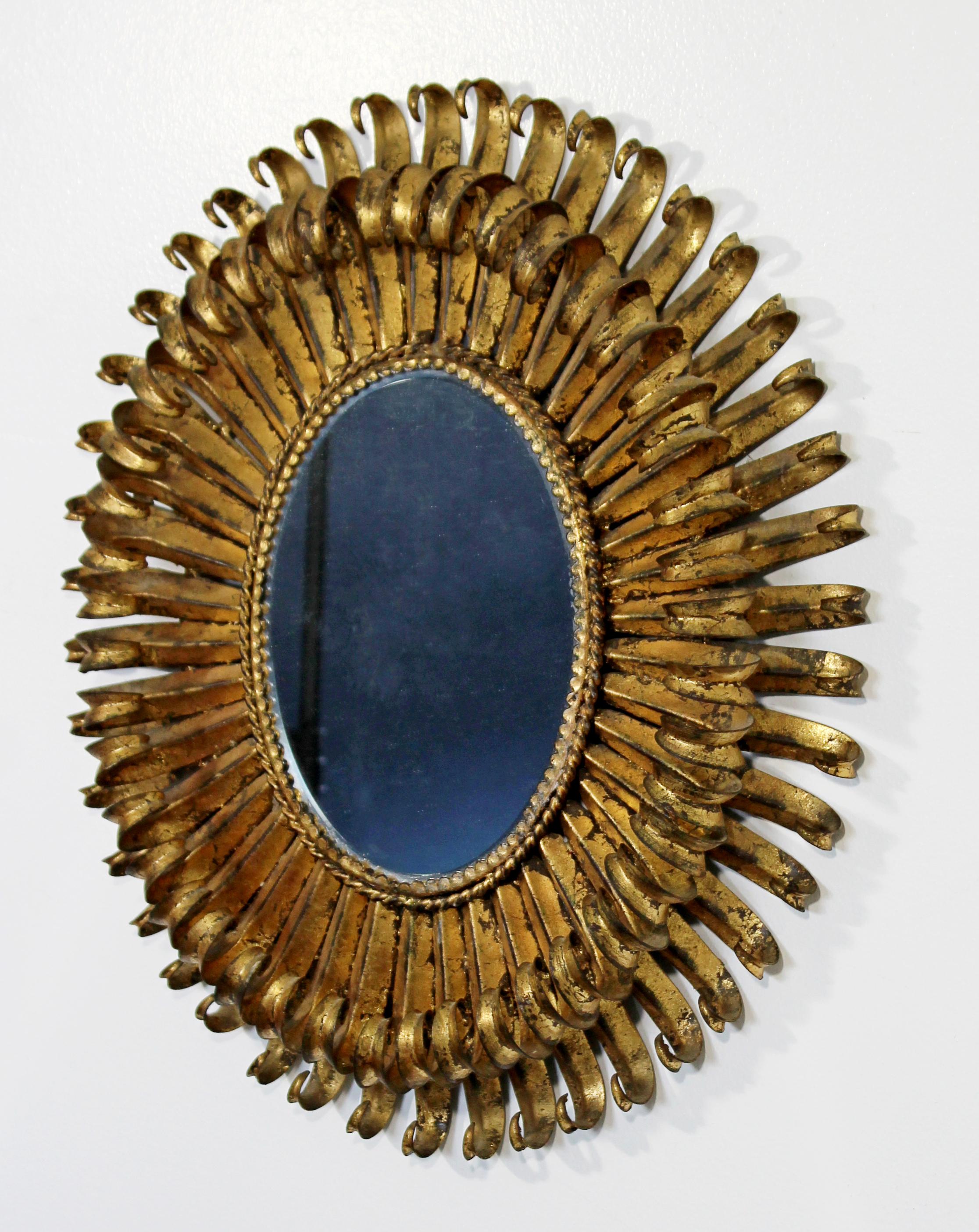 For your consideration is an incredible, gold gilt metal wall sculpture mirror, made in Italy, circa the 1960s. In excellent vintage condition. The dimensions are 17