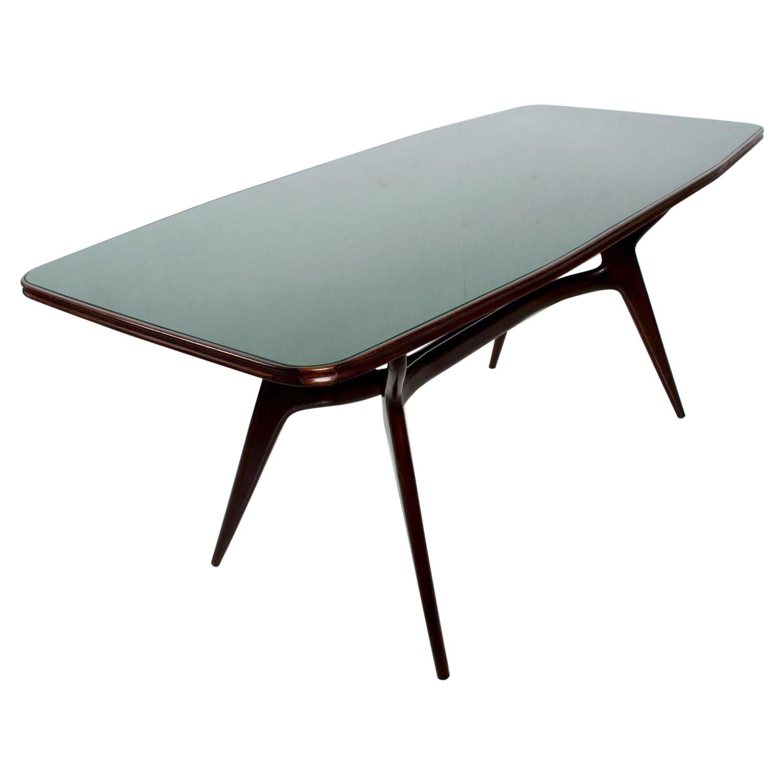 Mid-century Modern Italian Green Dining Table after ICO PARISI 1950s. 
Table has a lovely sculptural shape. Finished in mahogany. 
We are offering 6 Dining Chairs that match our ICO PARISI dining table.
See our listings.
30.75 H x 32.75W x 76