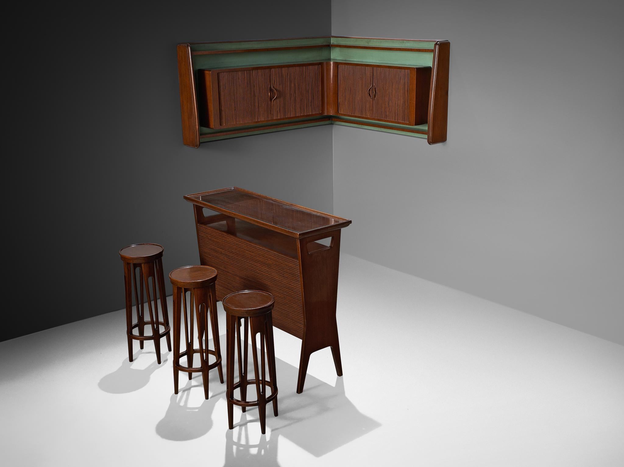Bar set including wall-mounted cabinet, counter element, and set of three barstools, walnut, Italy, 1950s 

Elegant, playful private bar with matching wall unit and stools. A divine set from the heart of Italy in the vibrant 1950s. The bar and other