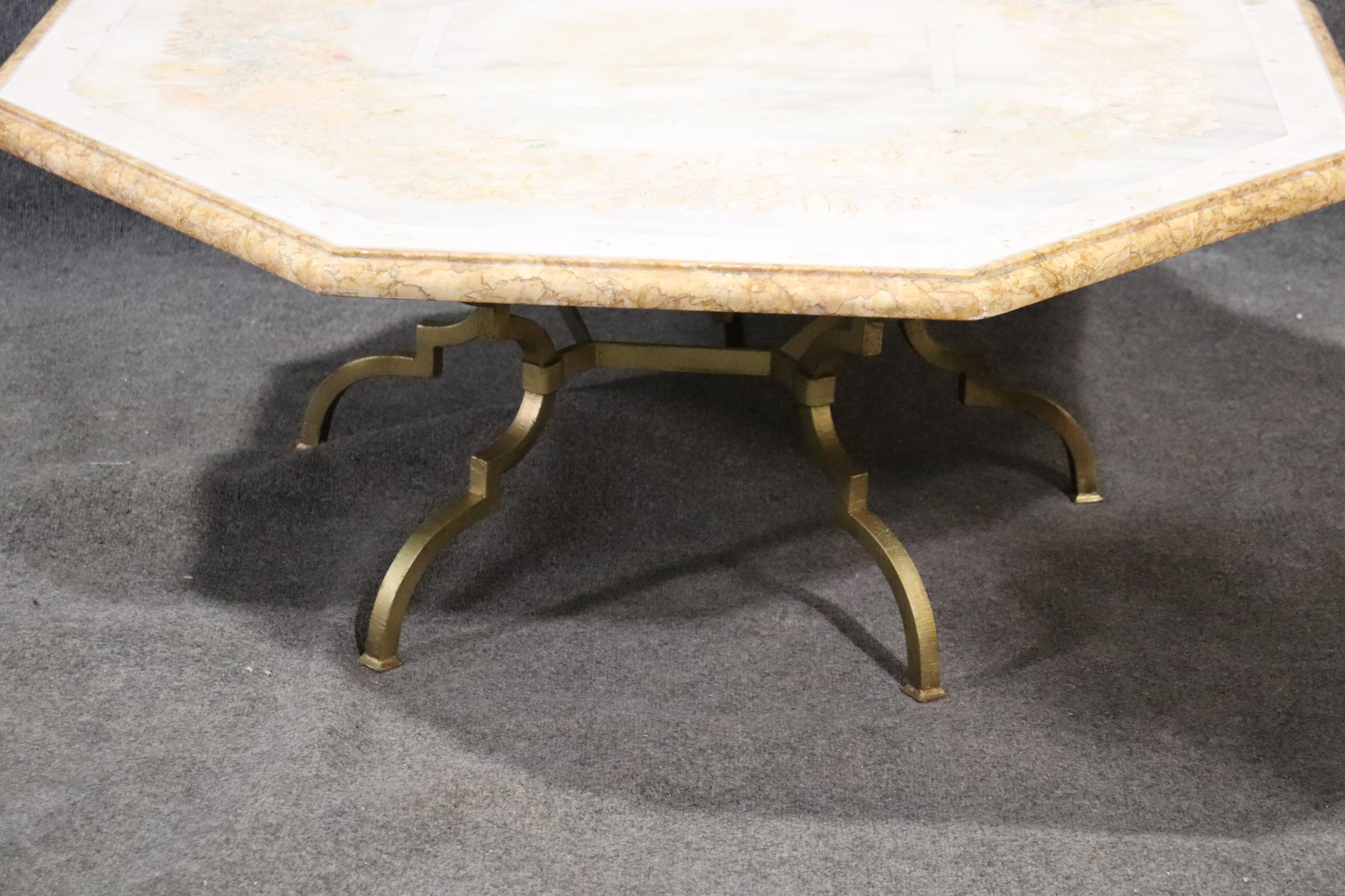 This is a superb and very uniquely designed Italian-made coffee cocktail table. The table features an inlaid marble top and a fine brass base. The table is in good vintage condition and is sure to be a unique focal point in your home. The table