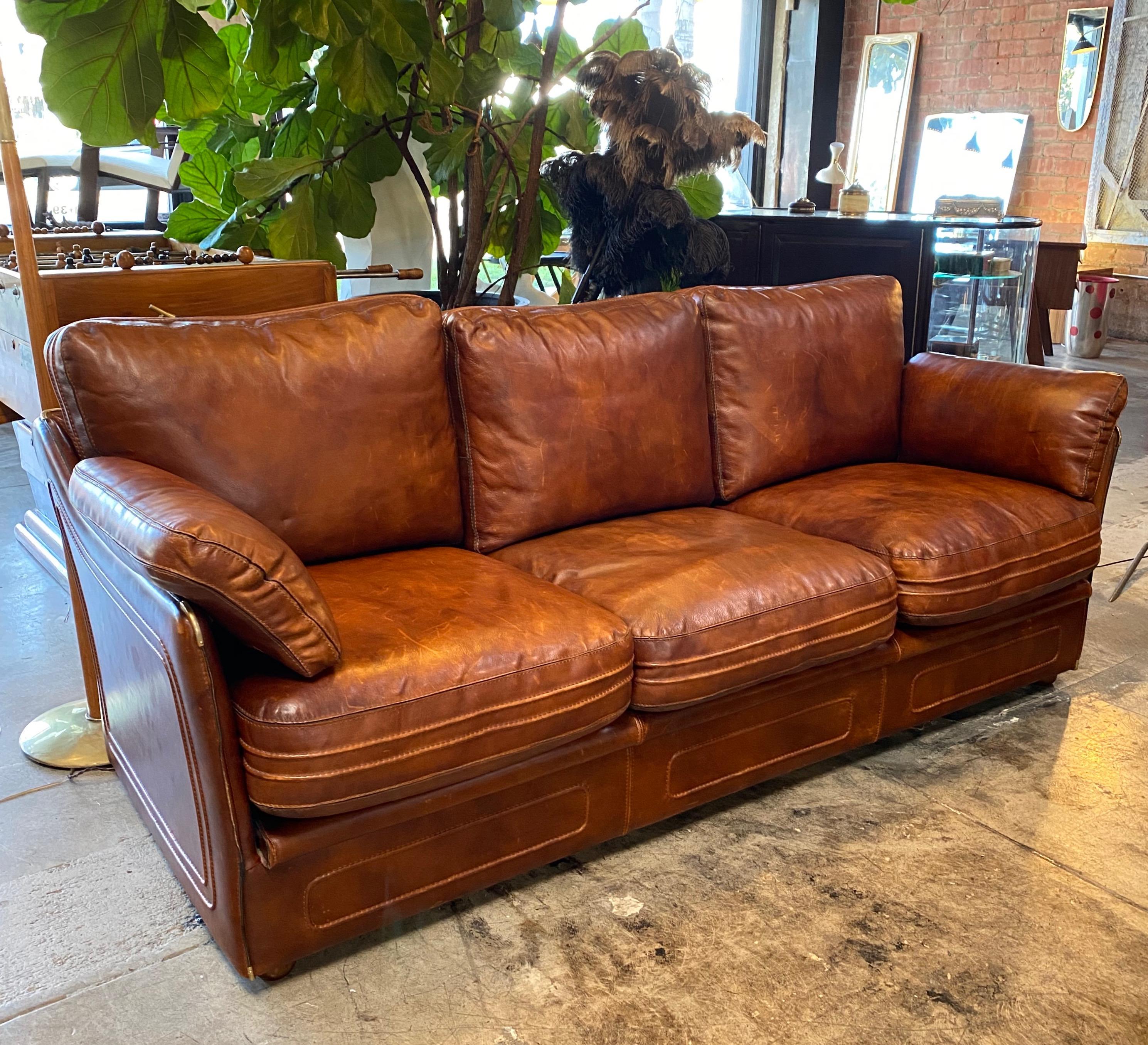 Mid-Century Modern Italian leather sofa, 1960s .The sofa is made out of high quality brown leather. The back and sit of the sofa is composed from three pillows. Armrests are covered with leather and have a soft stuffing in them for an extra