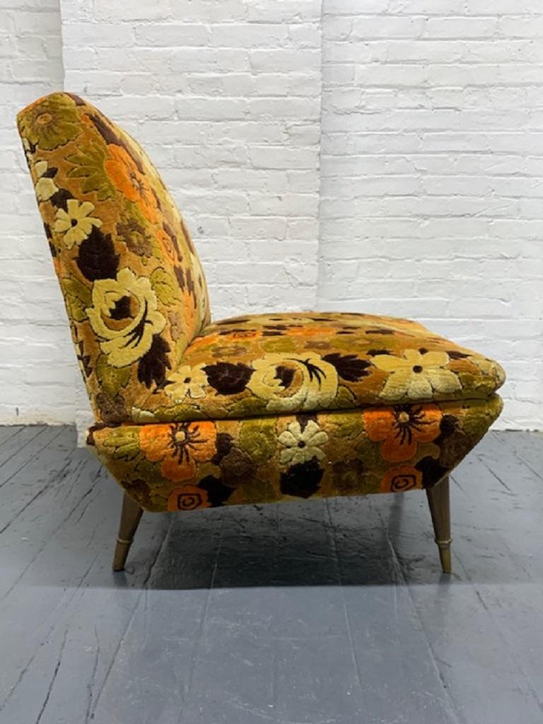Mid-Century Modern Italian lounge chair armless lounge chair with original floral upholstery. Has wood legs with brass sabots.