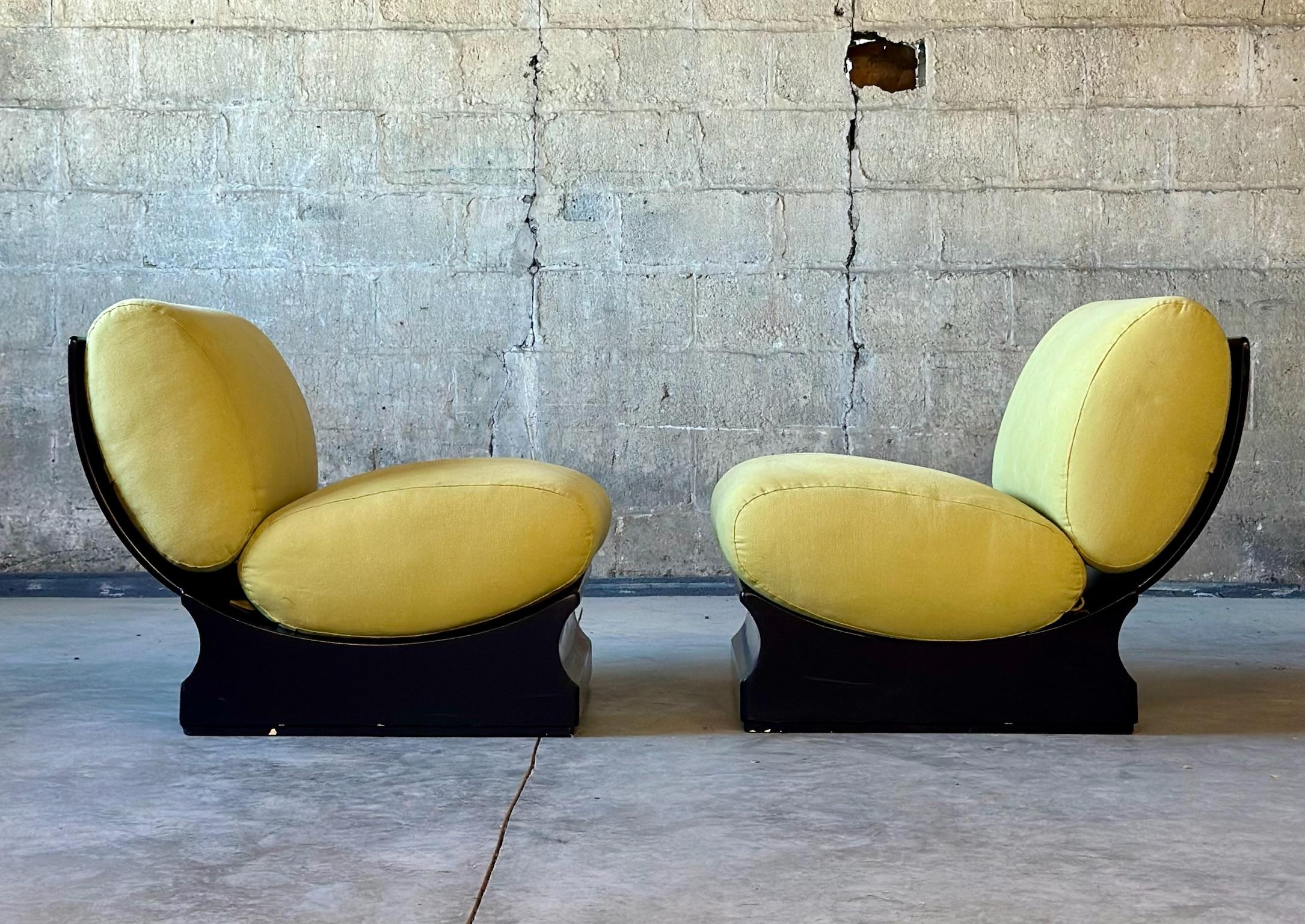 An unbelievable pair of Mid-Century lounge chairs, circa late 1960s - early 1970s from Italy. Black lacquered acrylic and bright, poppy chartreuse cushions complete the chair. Slight recline to the back provides an extremely ergonomically fine chair