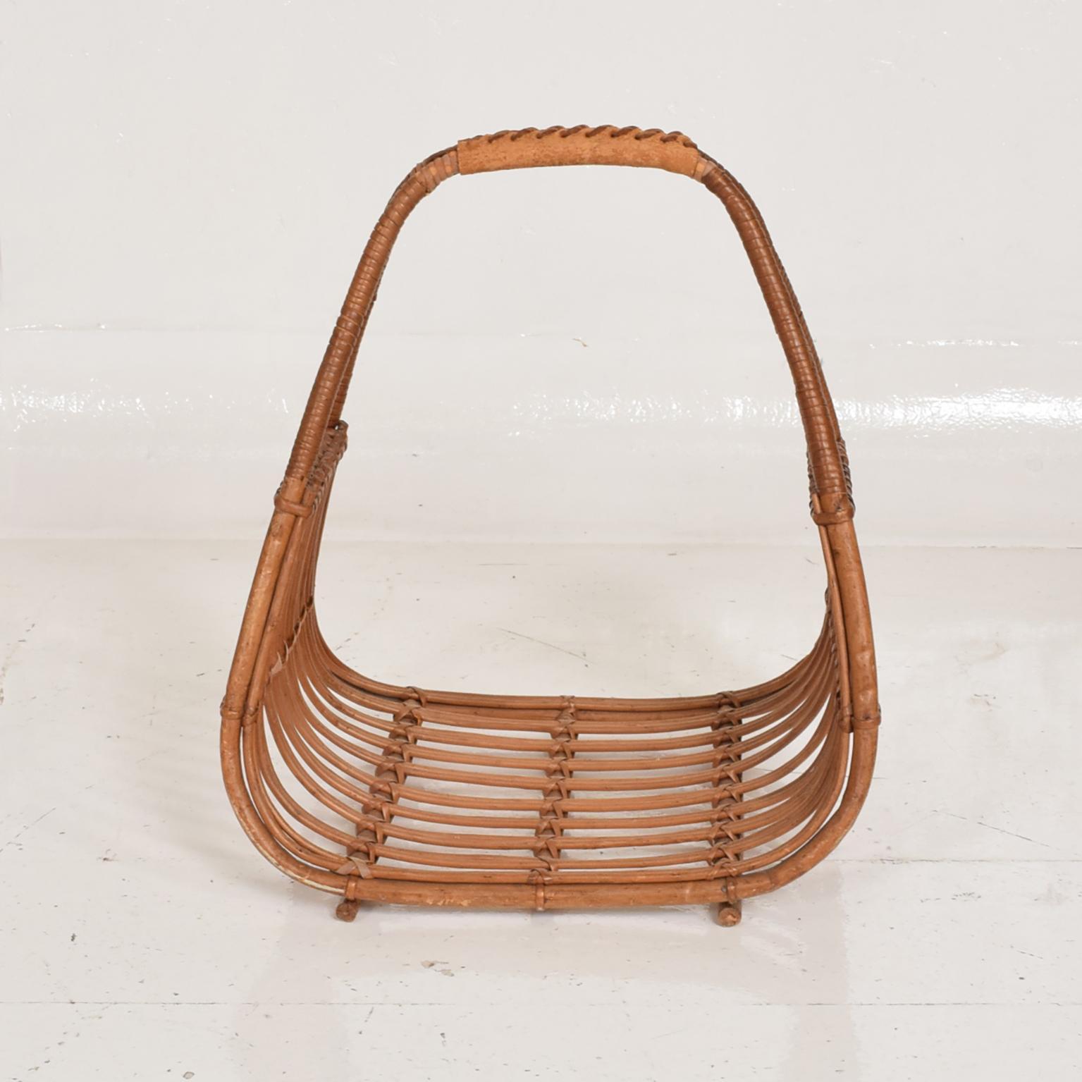 For your consideration, a Mid-Century Modern Italian magazine rack holder basket after Franco Albini.

Made in Italy circa the 1960s. Sculptural shape in rattan and leather. 

Unmarked. 

Dimensions: 8 1/2