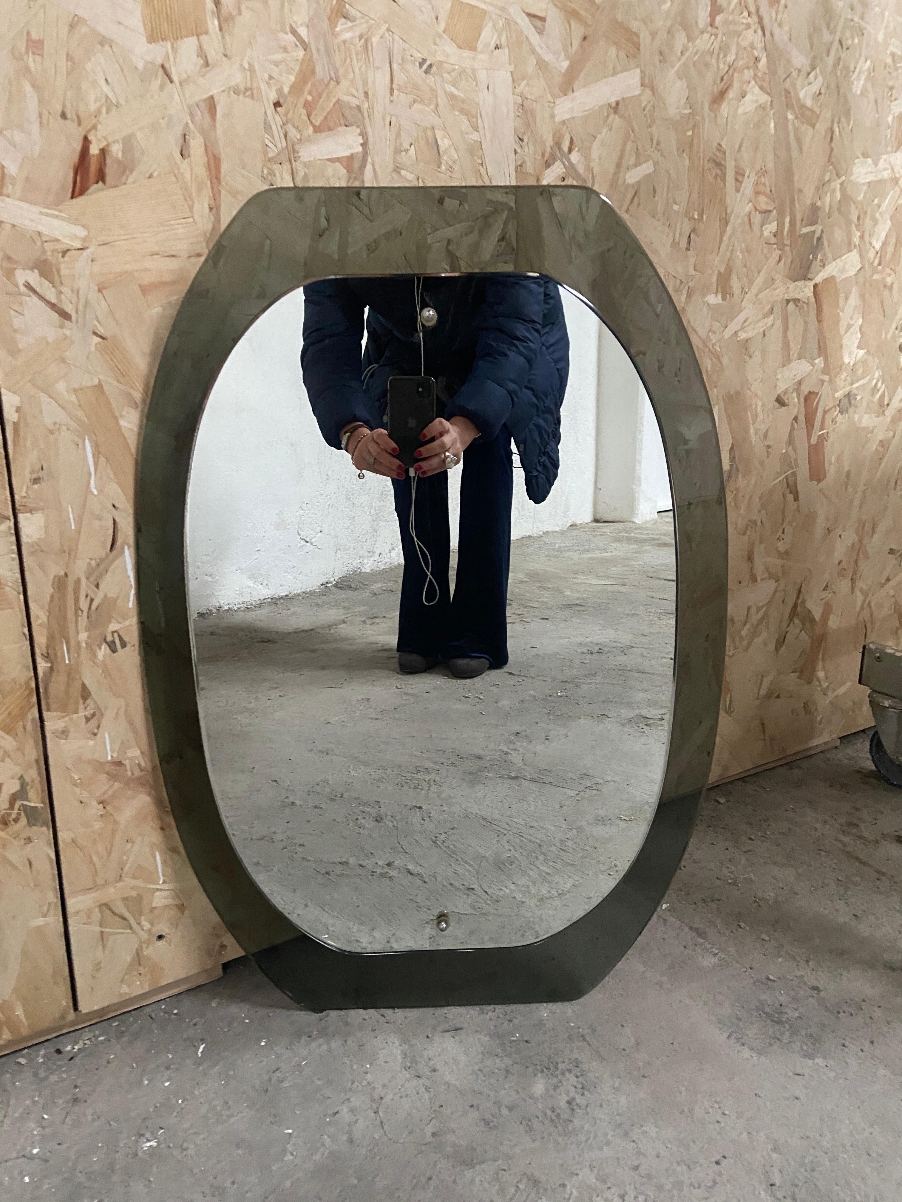 Mid-Century Modern Italian mirror with green beveled Murano glass frame in the style of Fontana Arte. 
The mirror can become a set with its pair of Murano glass sconces as showed in the photos
Price for the set on request.
 