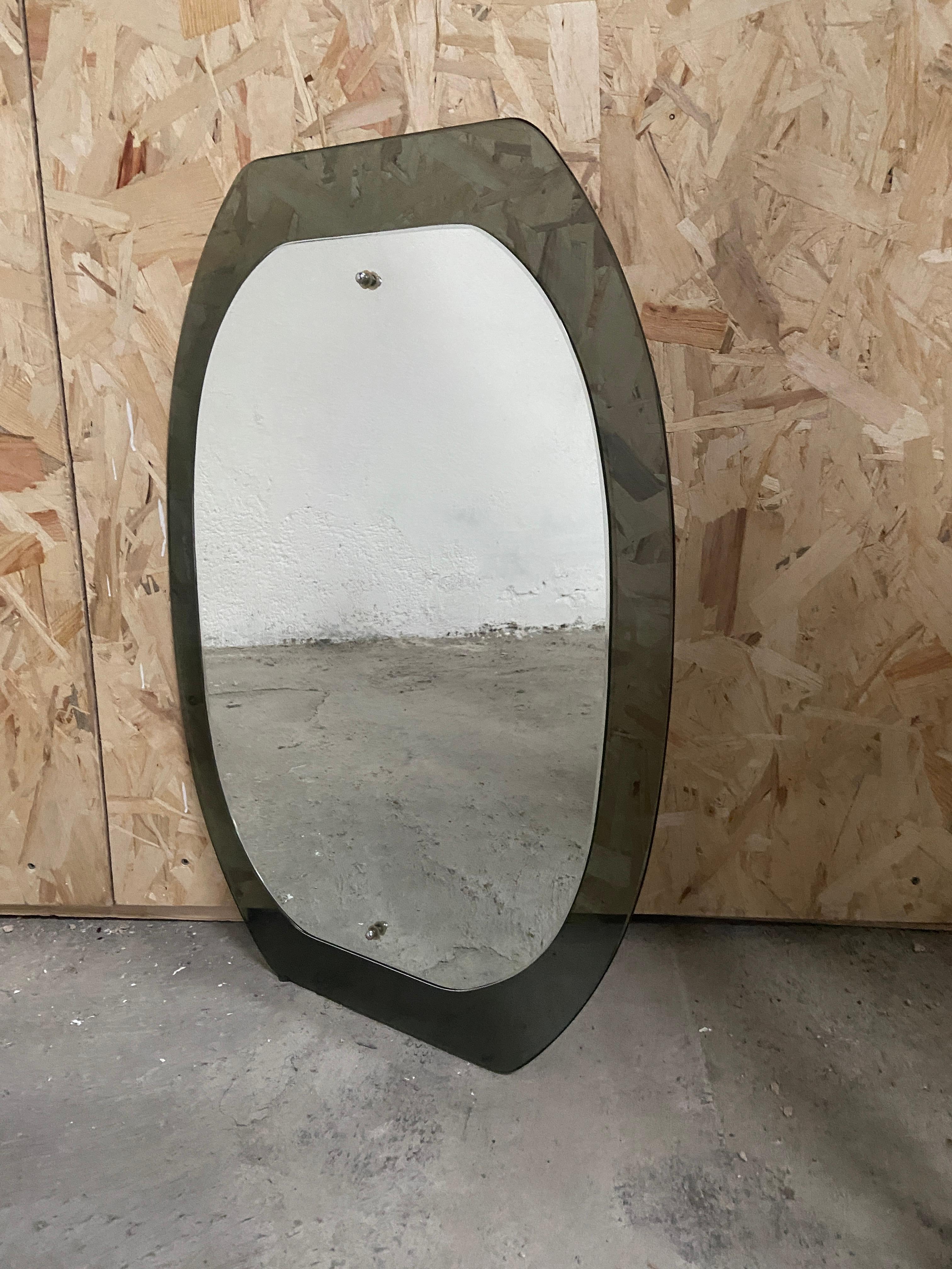 Mid-Century Modern Italian mirror with green beveled Murano glass frame in the style of Fontana Arte. 
The mirror can become a set with its pair of Murano glass sconces as showed in the photos.
Price for the set on request.
 