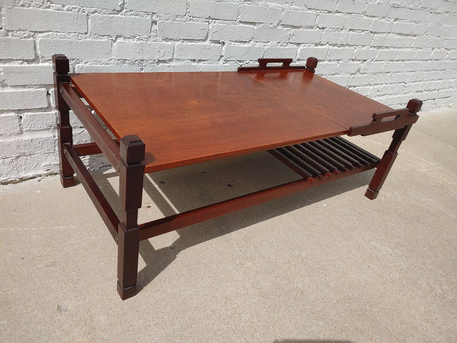 Mid Century Modern Italian Modern Teak Coffee Table

Above average vintage condition and structurally sound. Has some expected slight finish wear and scratching. Edges have some dings and a couple small veneer chips. Portion of top is removable and