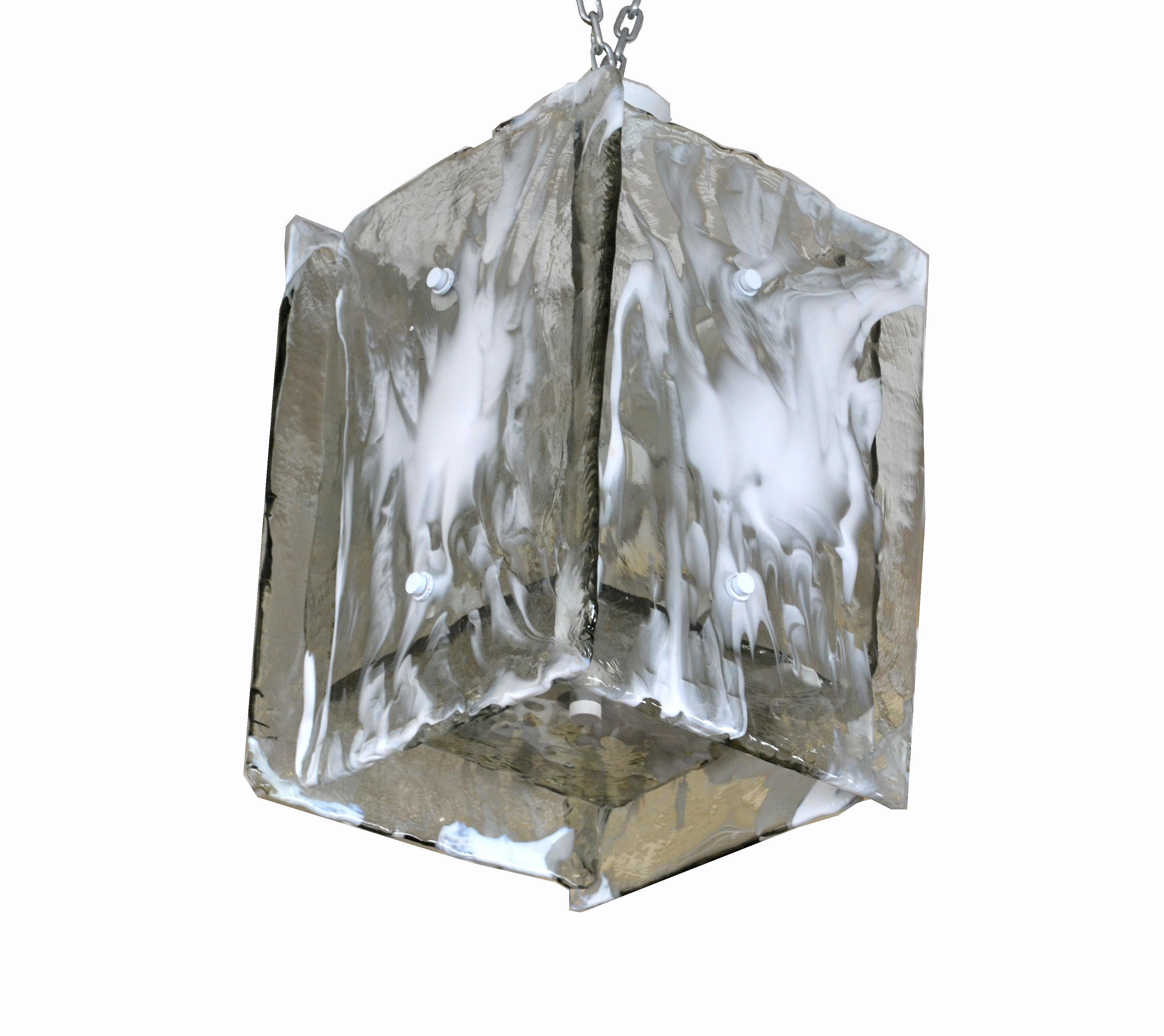 Mid-Century Modern Italian Murano art glass textured chandelier by Carlo Nason for Mazzega.
5 transparent and white textured Murano glass panels are mounted to a metal frame with 8 candelabra light bulbs.
Wired for the US and takes 8 candelabra