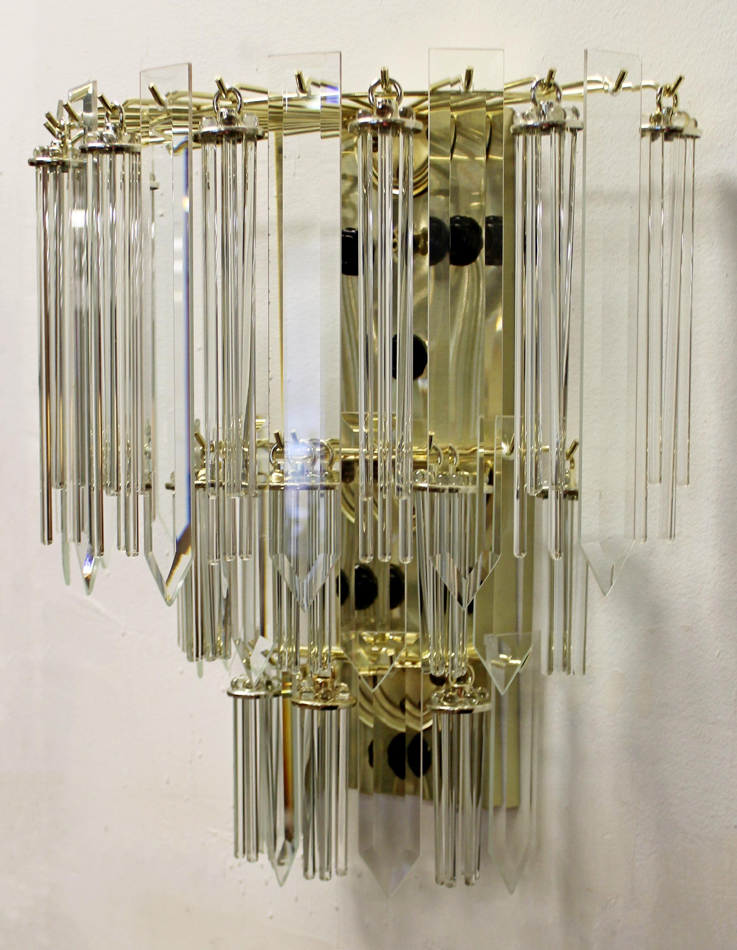 For your consideration is a Murano wall sconce, made of brass and glass, circa 1960s. In excellent vintage condition. The dimensions are 16.5