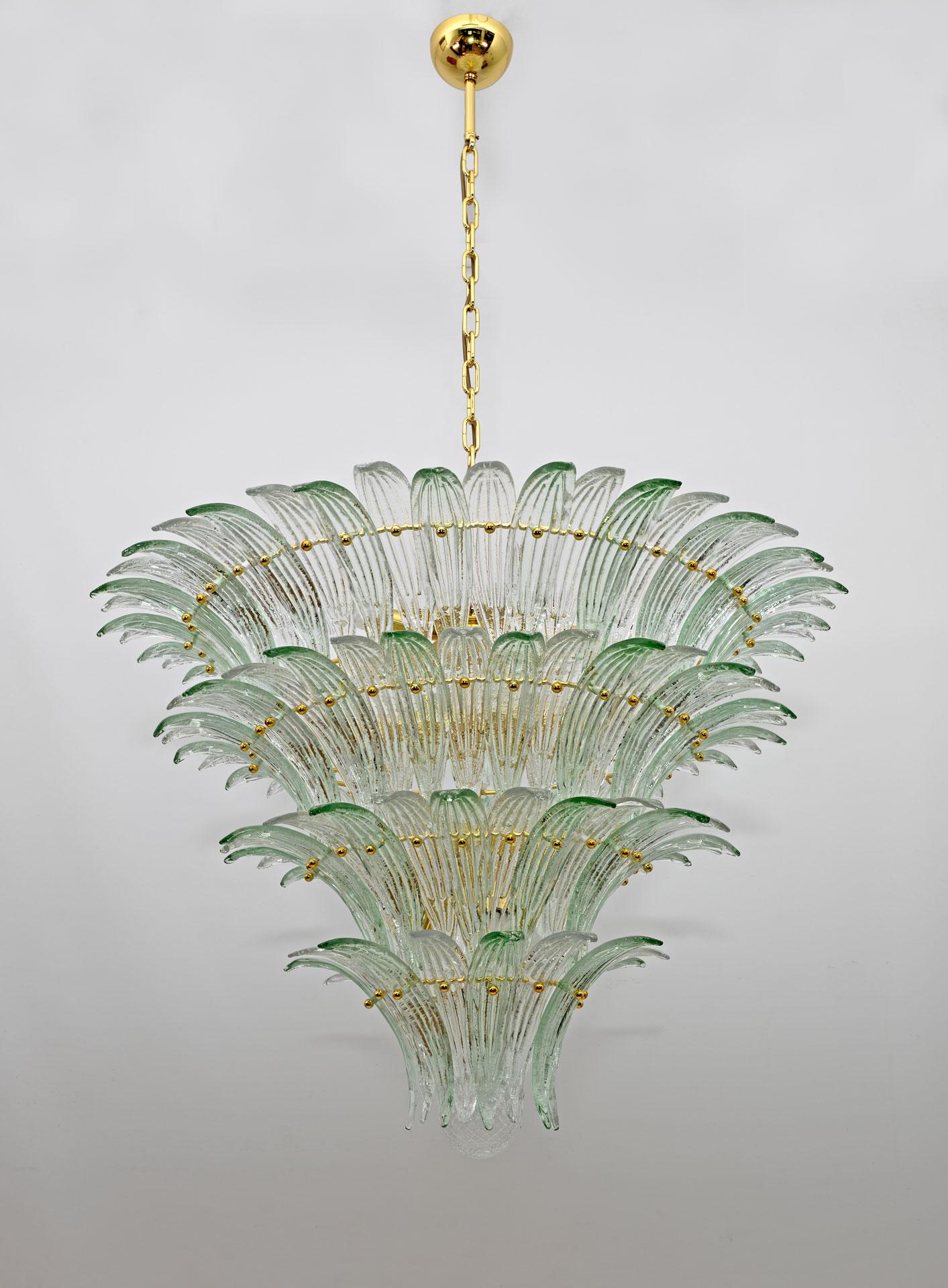 Large mid-century modern palmette chandelier in Murano glass, Barovier and Toso style, 1990s Italy. The chandelier is composed of a gold and brass painted metal structure, green and transparent Murano glass palmettes. The large Italian chandelier