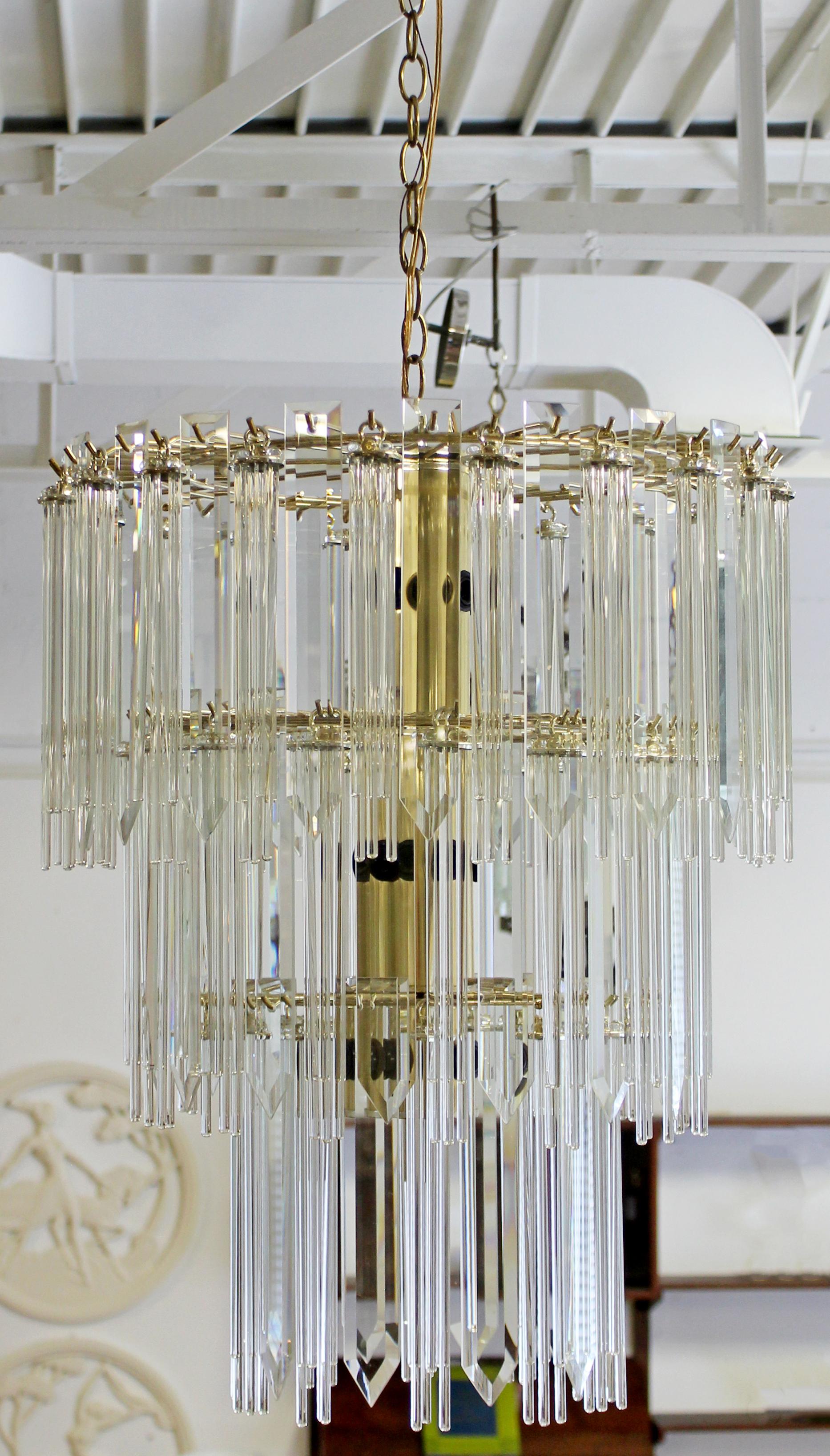 For your consideration is a spectacular, tiered Murano glass and brass chandelier, made in Italy, circa the 1970s. In excellent condition. The dimensions are 19